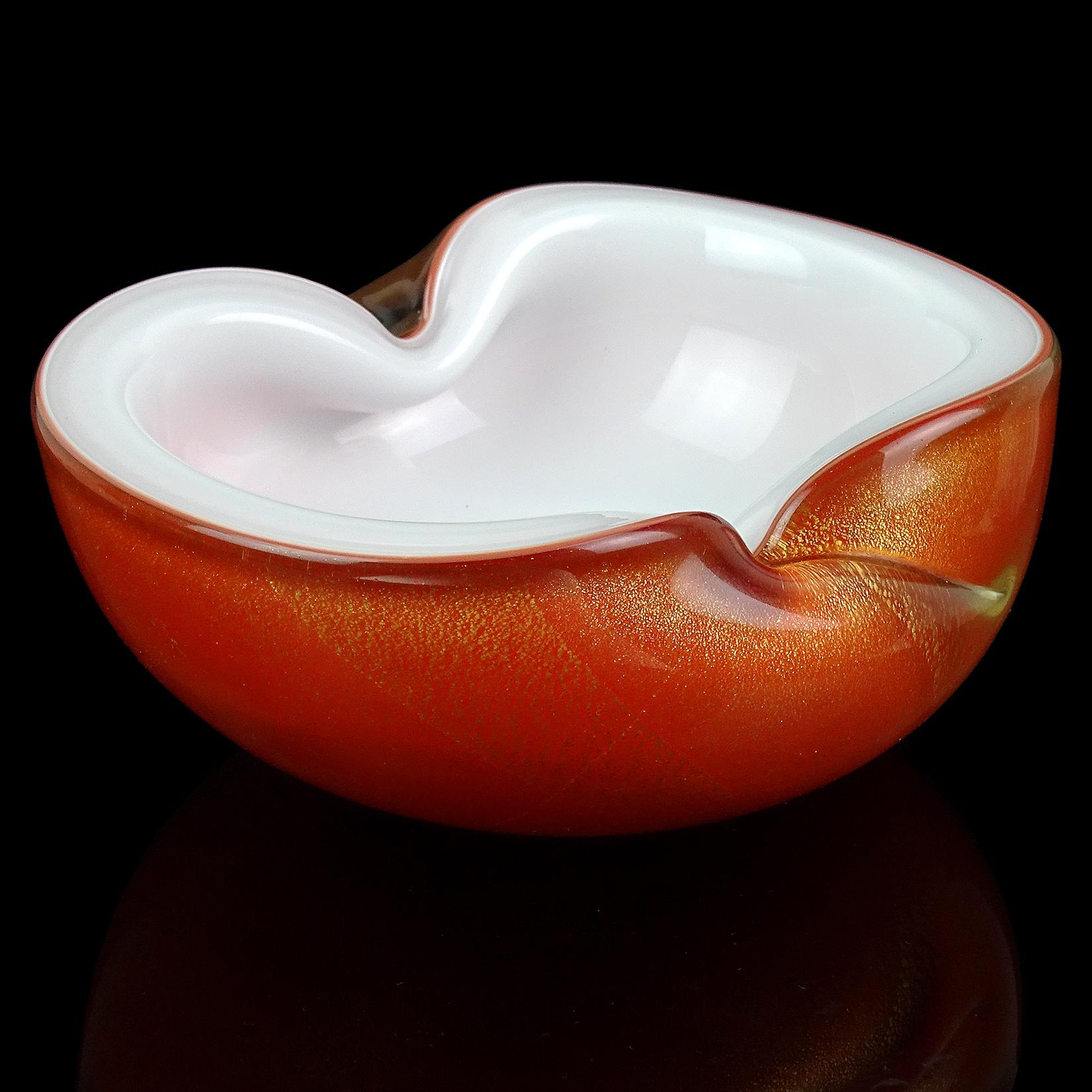 Beautiful vintage Murano hand blown orange over white, and gold flecks Italian art glass decorative bowl / ashtray. Documented to Master glass artist and designer Alfredo Barbini, circa 1950-1960. Published design. The color is a rich 