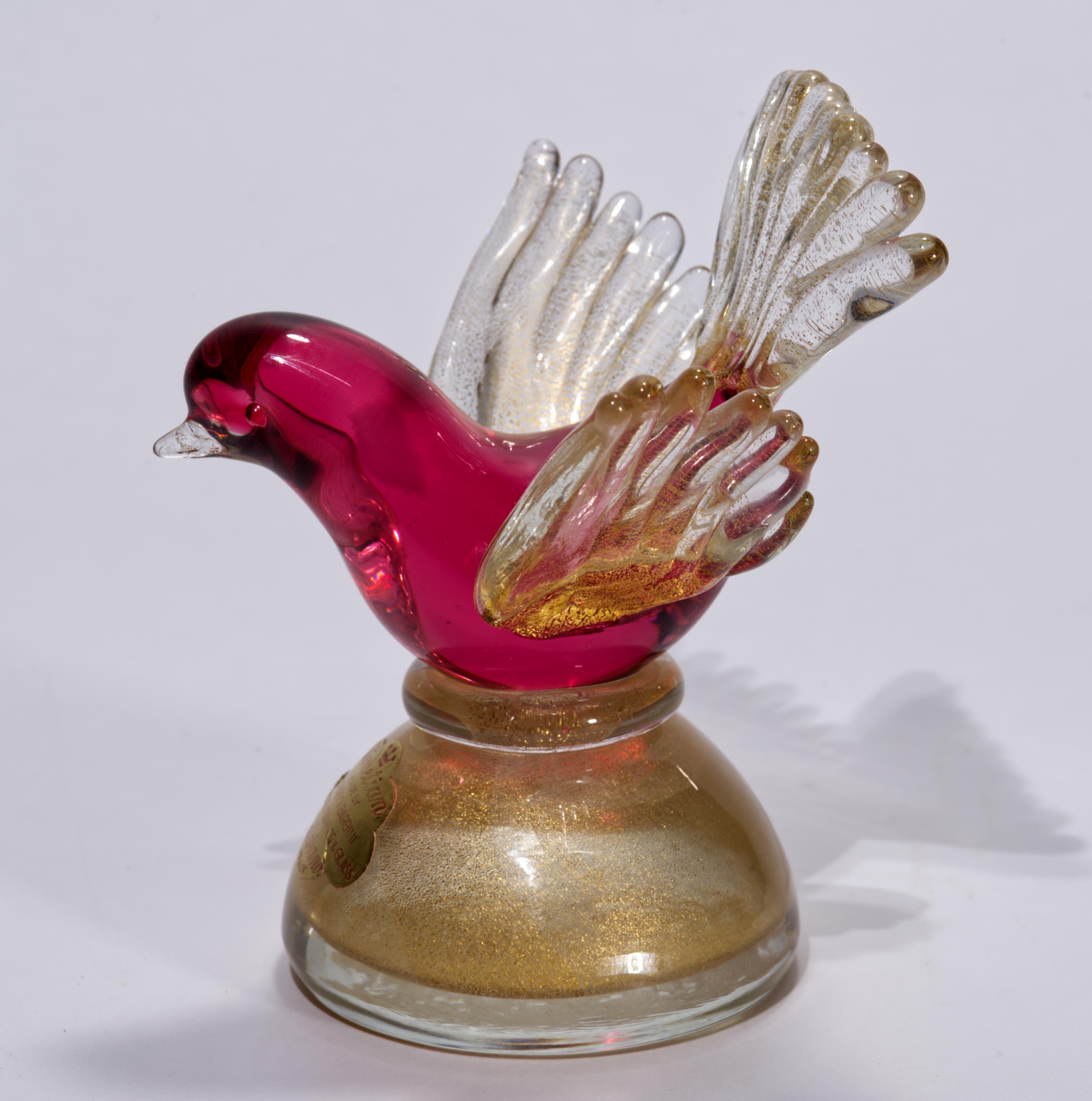 Murano hand blown Italian art glass bird sculpture or figurine features a minimal, restrained palette of dark red and off-white with delicate gold lead, or aventurine, accents. The colored glass is encased in a layer clear glass in sommerso