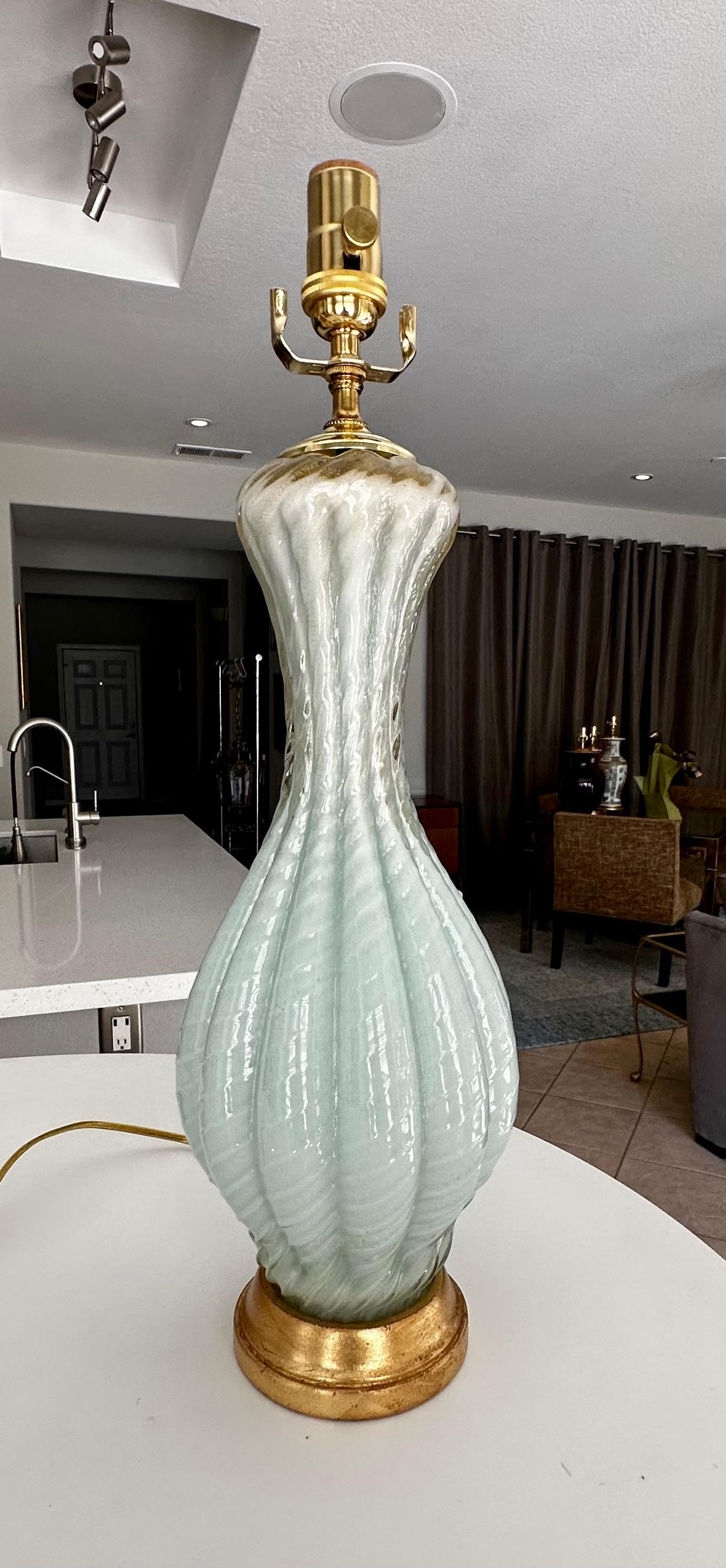 Murano Italian handblown light seafoam green colored glass table lamp. The glass lamp body has bias raised ribbing with light gold inclusions, resting on an giltwood base. Newly wired with new 3 way brass socket and cord. Glass alone is 14.5