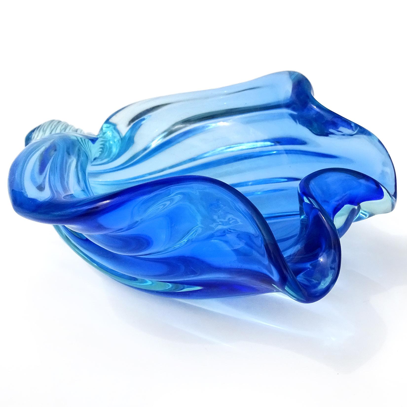 Beautiful vintage Murano hand blown Sommerso cobalt blue Italian art glass decorative seashell sculptural bowl. Documented to designer Alfredo Barbini, and published in his catalog. The shell has a ribbed design with flared rim. The color is blue,