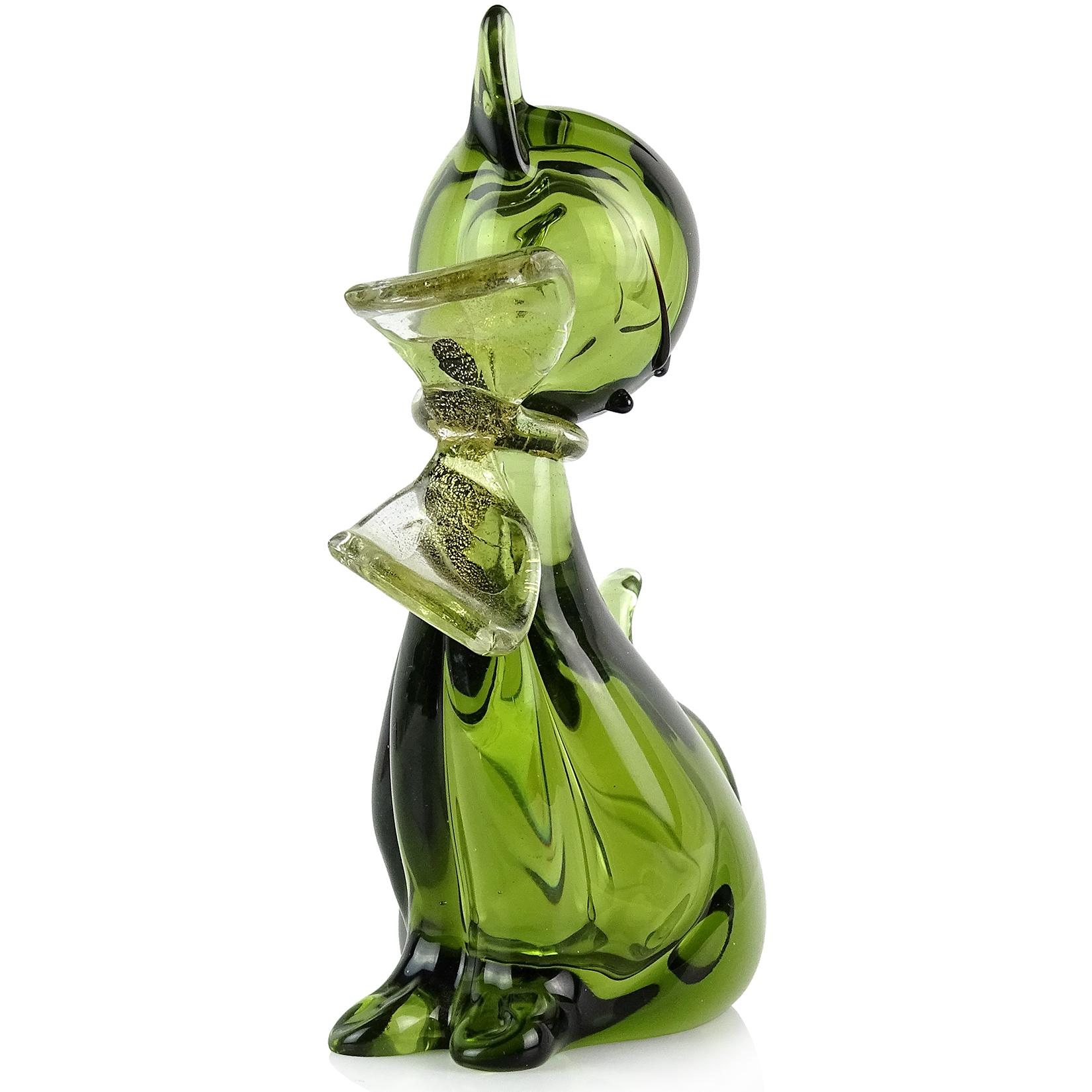 Beautiful vintage Murano hand blown Sommerso green and gold flecks Italian art glass kitty cat figurine. Documented to designer Alfredo Barbini. The kitten has a gold leaf bow around its neck. Very elegant shape, with cute face with black accents,