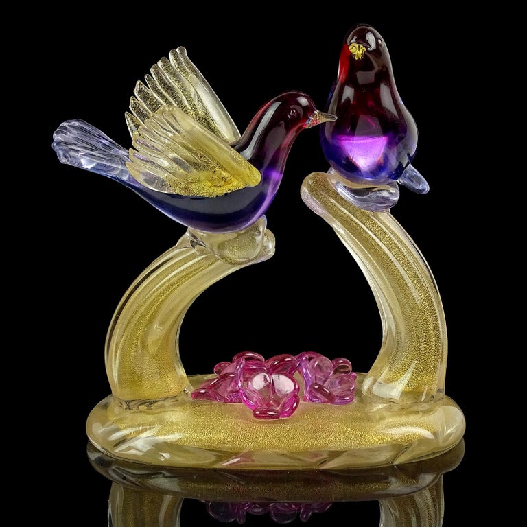 Gorgeous vintage Murano hand blown Sommerso with gold flecks art glass courting love birds sculpture. Documented to designer Alfredo Barbini. The bird colors create an Ombre fade, from reddish amethyst purple to light blue. The branches and base are