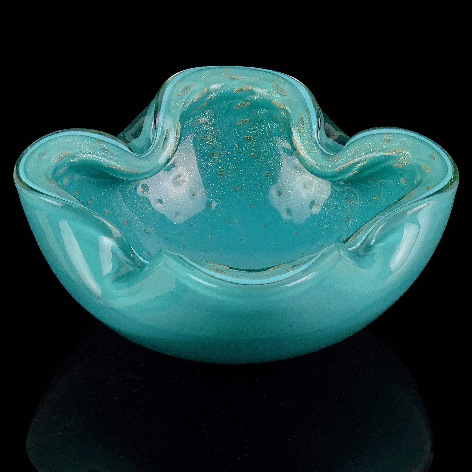 Beautiful vintage Murano hand blown teal blue/green and gold flecks Italian art glass bowl. Documented to designer Alfredo Barbini, circa 1950s. The bowl has four indents on the rim, with 