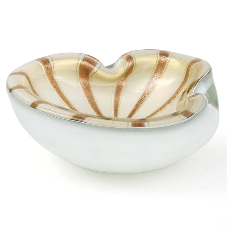 Beautiful, large vintage Murano hand blown white, gold and aventurine flecks Italian art glass bowl. Documented to designer Alfredo Barbini, circa 1950-1960s. It has a stripe pattern of glittery copper aventurine and filled with gold leaf on the
