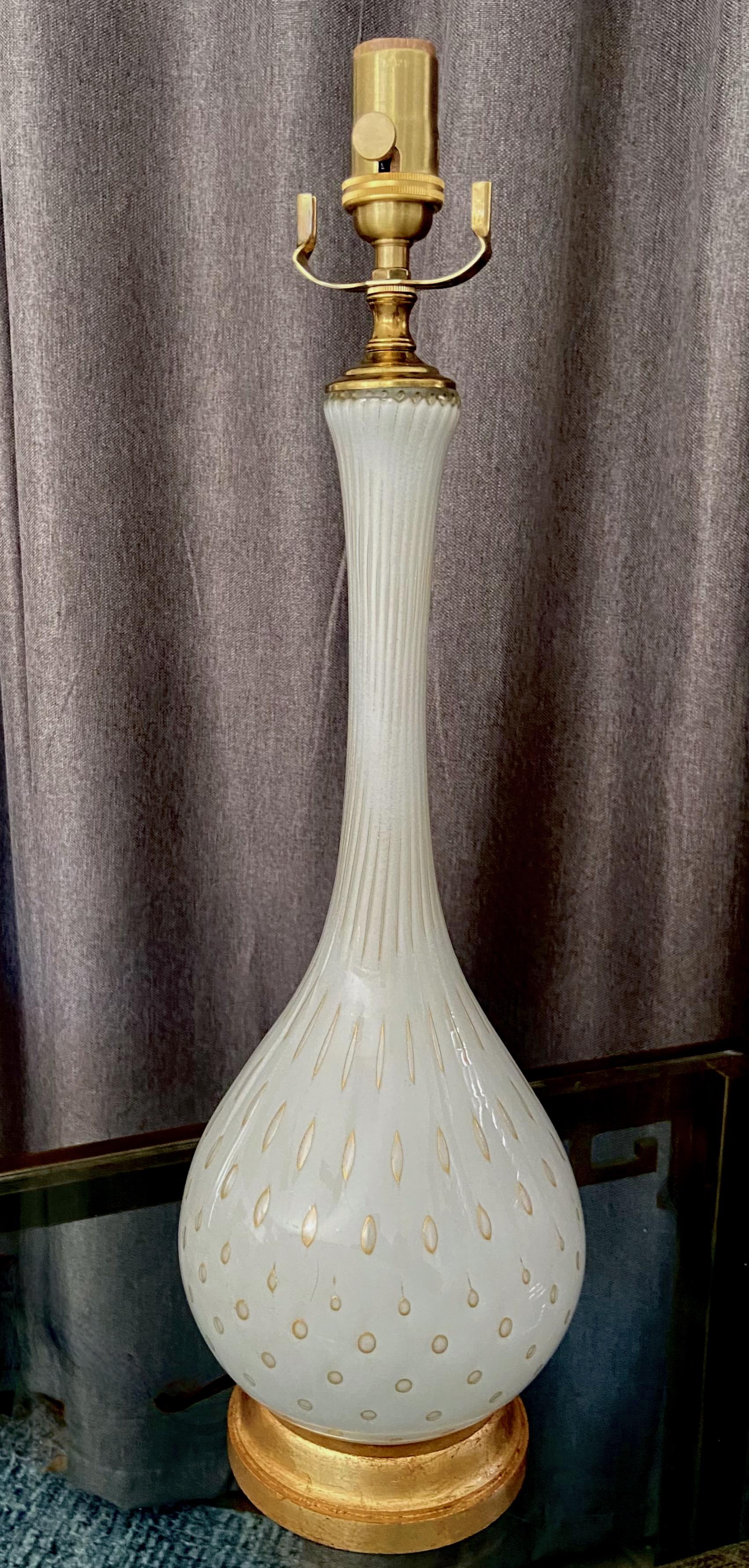 Murano Italian handblown white and gold controlled bubbles glass table lamp by Alfredo Barbini. The lamps rest on giltwood base rewired with new brass 3 way socket and rayon covered cord. Glass alone is 17