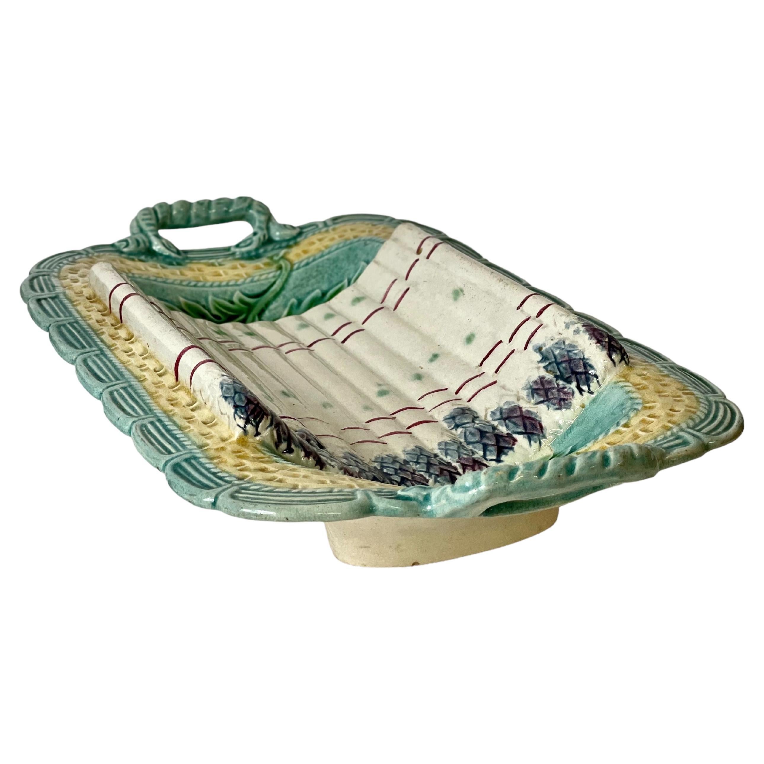 A wonderful late 19th century French glazed 'Barbotine' Majolica asparagus serving platter with handles, wonderfully decorated in vibrant pastel colours, with haut-relief modelled and glazed asparagus stalks against a woven wicker pattern and a