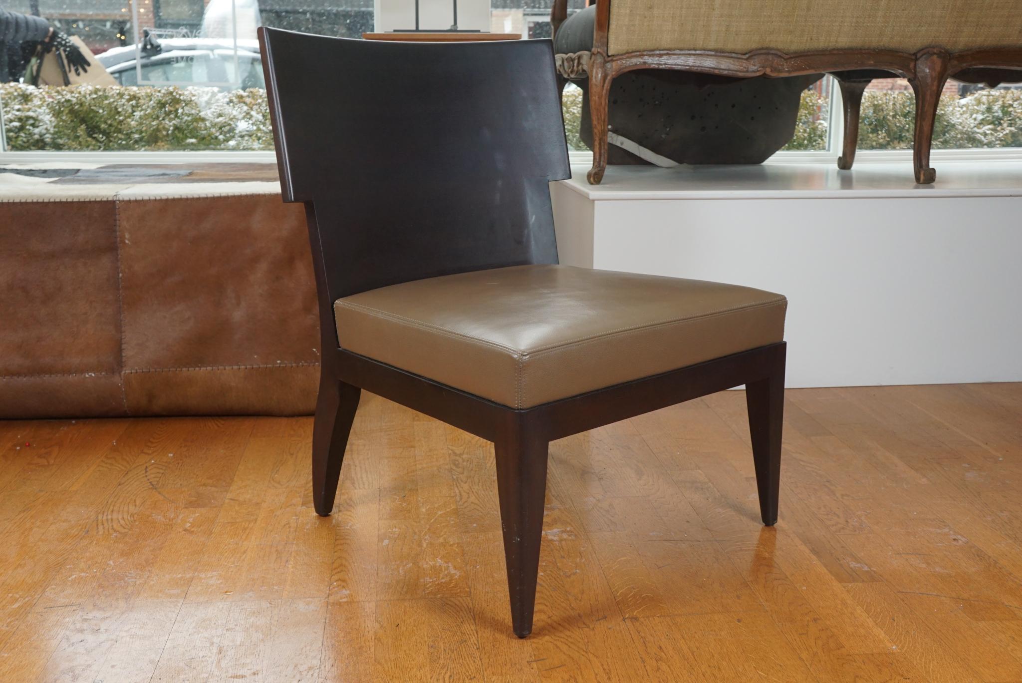 A sleek and shapely side chair designed by Christian Liaigre for Holly Hunt. This handsome chair has a finely detailed wood back and sits on a wood frame with tapered legs and a leather upholstered seat.