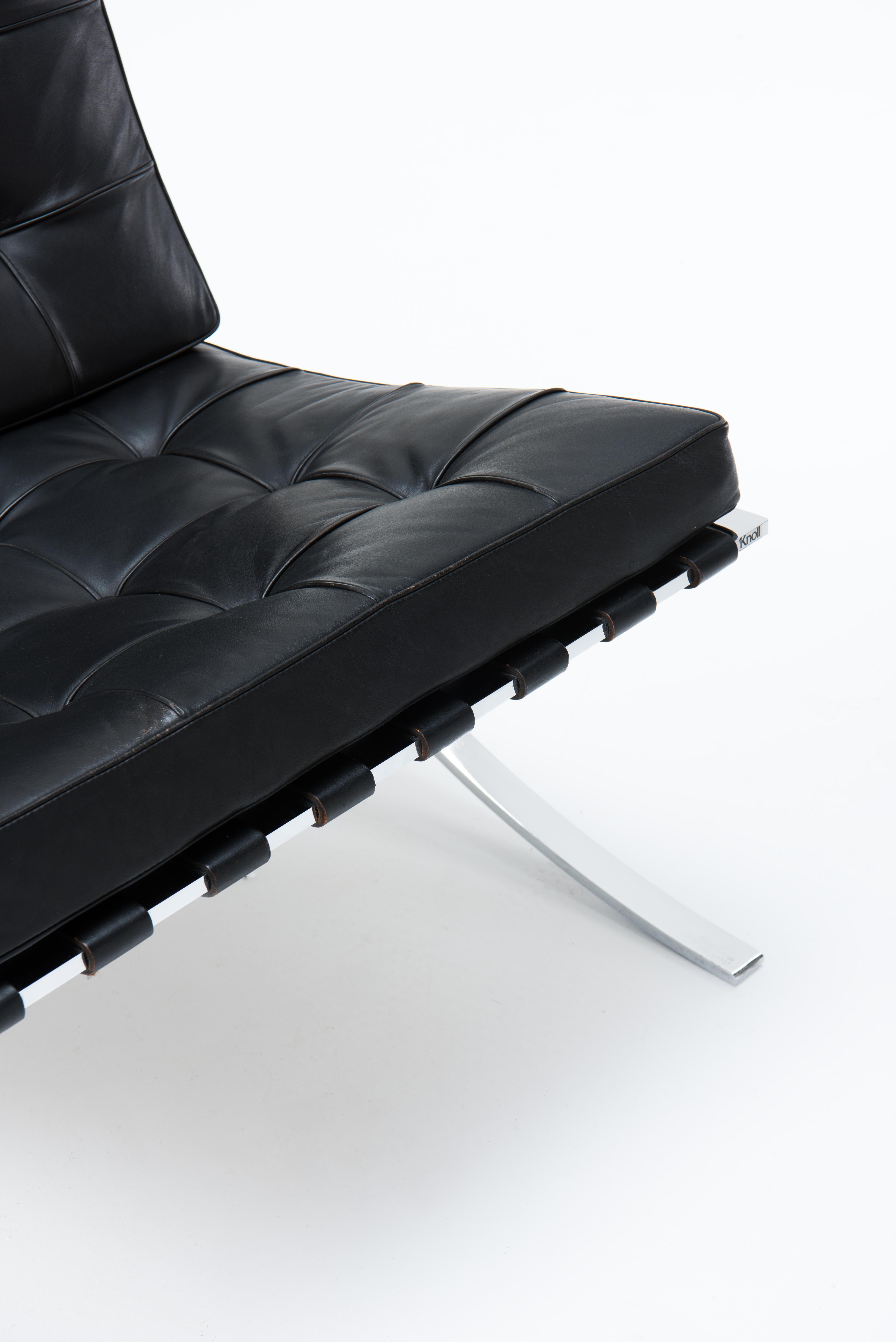 An iconic ‘Barcelona’ Chair in black leather, with foot stool. Designed by Mies Van der Rohe for the 1929 Barcelona International Exposition. The chair is  produced by Knoll International in late 70's. The frames are made of chrome plated steel with