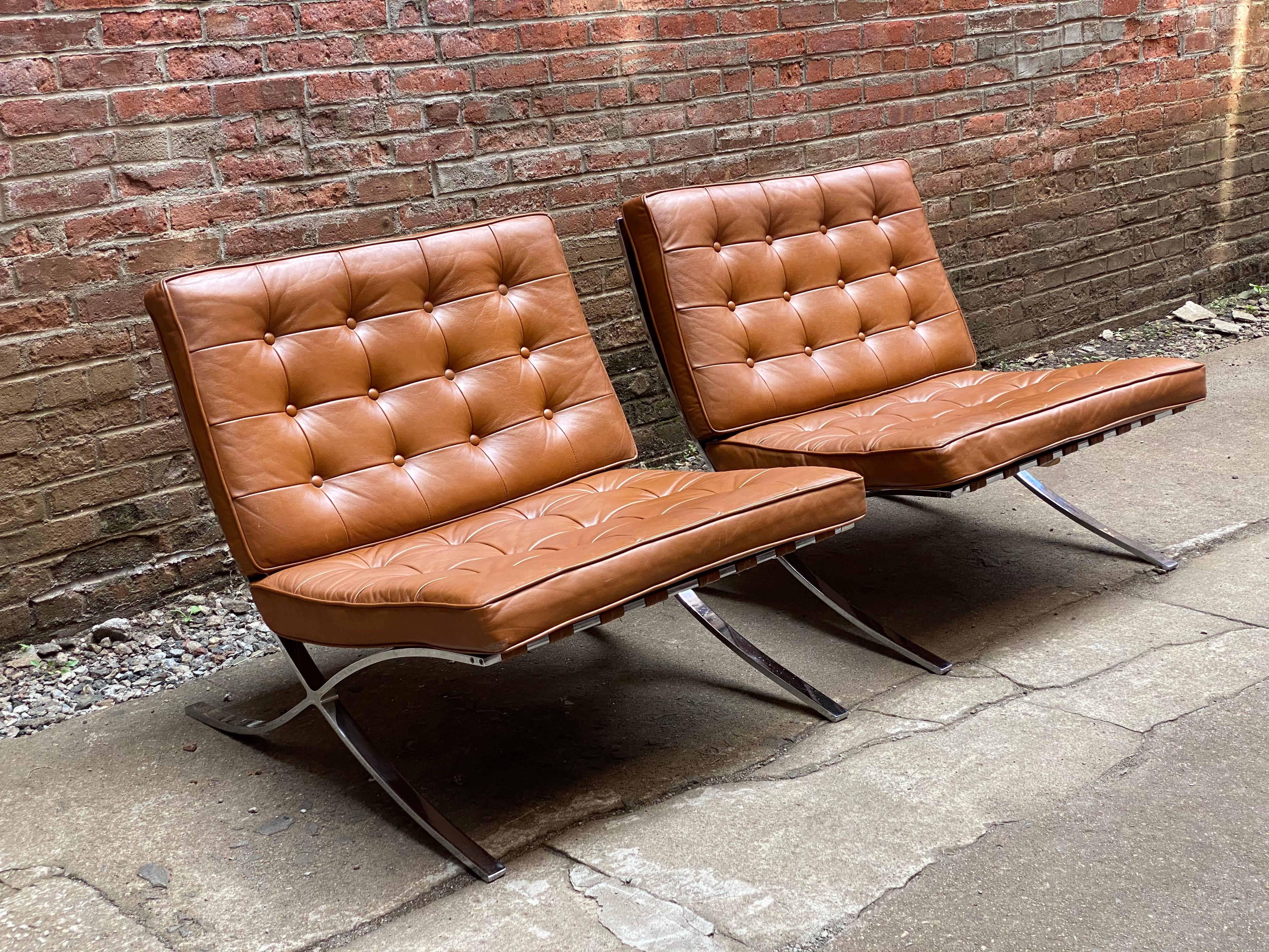 Pair of Barcelona style chairs by Charlton Company, Inc., Leeminster, Mass, circa 1970-1980. Chrome plated flat bar steel with butterscotch leather cushions. The cushions snap in place. The chrome plating and cushions are in very good condition with