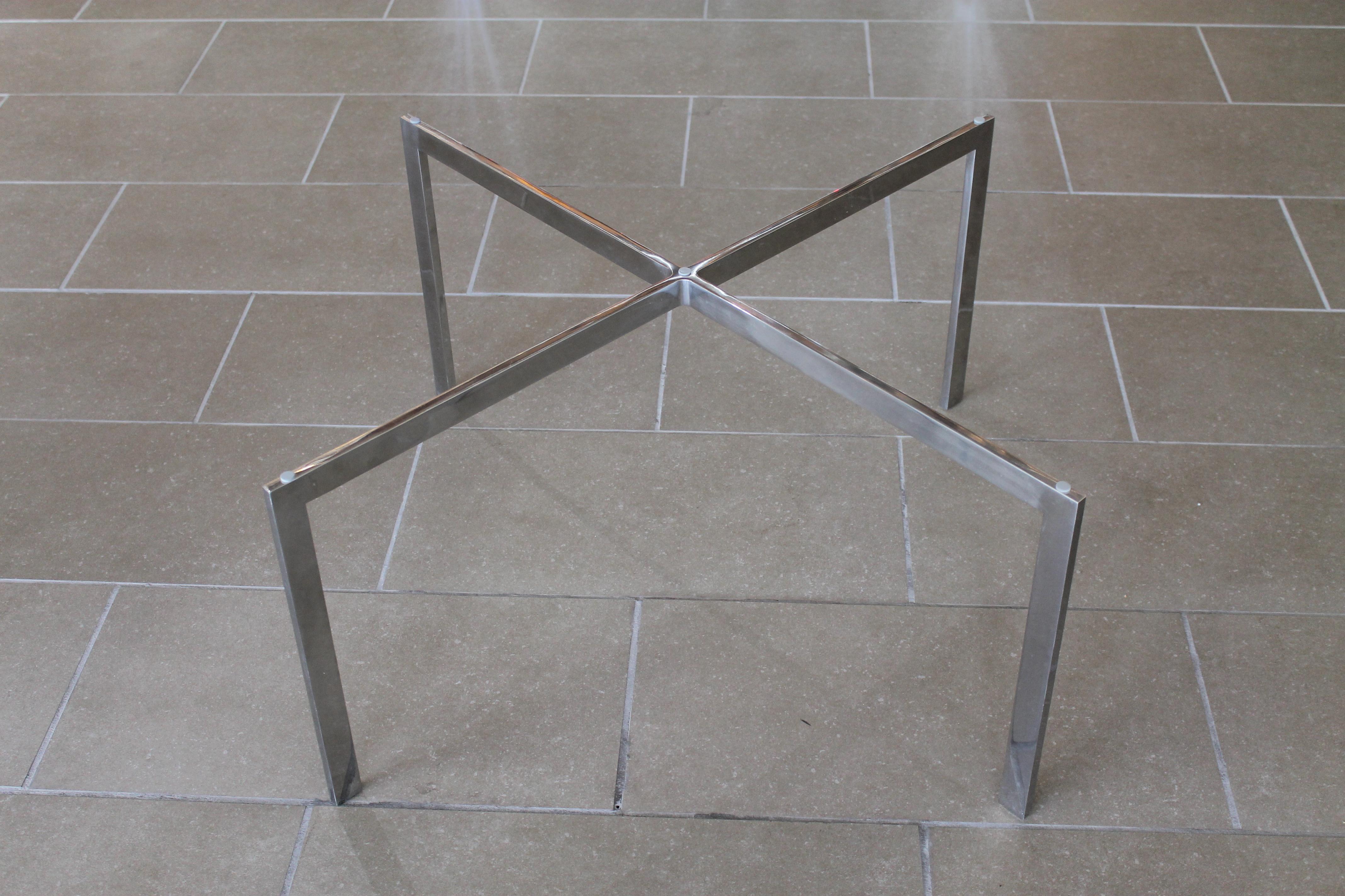 Polished Chrome Barcelona coffee table by Ludwig Mies van der Rohe for Knoll. These were from the Northrop Grumman Corporation as noted on the tag underneath table. Base is 27.25” wide, 27.25” deep and 16” high. Clear glass top is 29” wide, 31