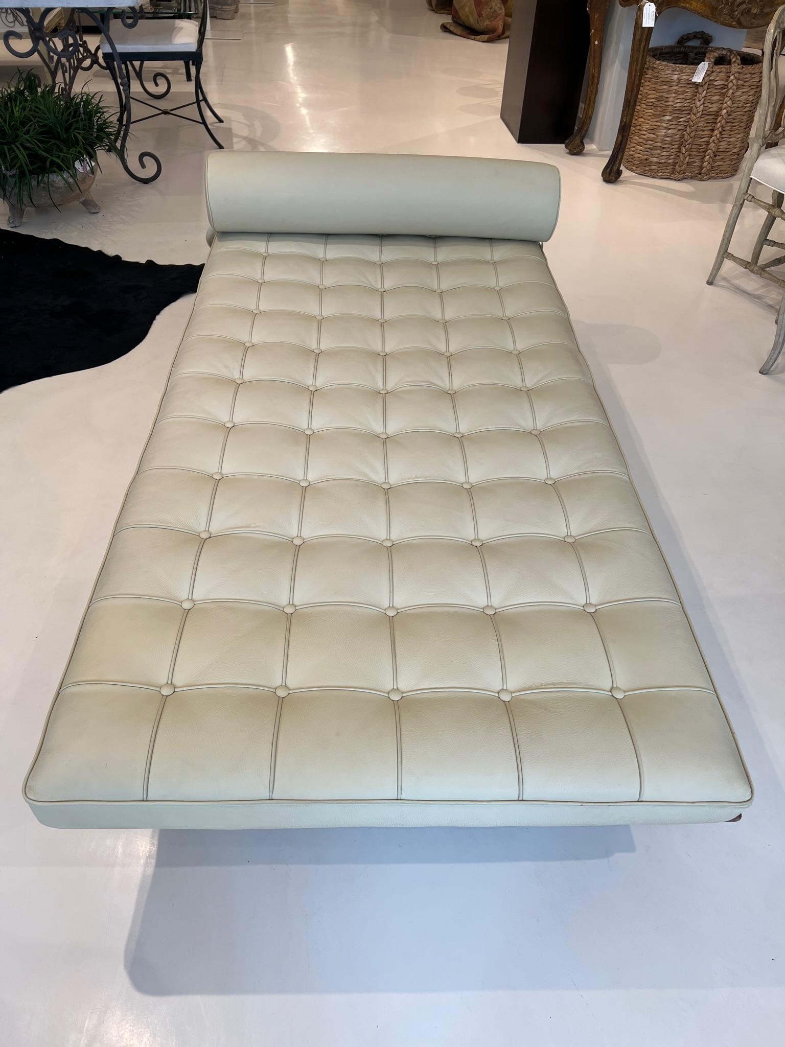 Chic, everlastingly appropriate. Large platform daybed in tufted cream colored leather with a roll headrest.