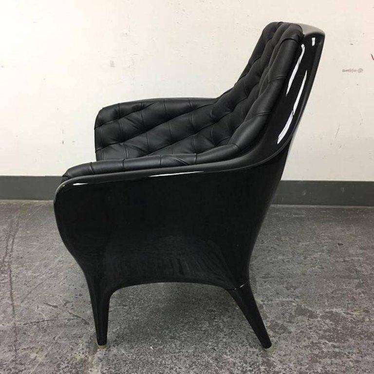 A Poltrona Showtime chair designed by Jaime Hayon for Barcelona designs. The frame is composed of highly black chair frame of rotomolded polyethylene. Upholstered in black leather and bright black lacquered. 


 