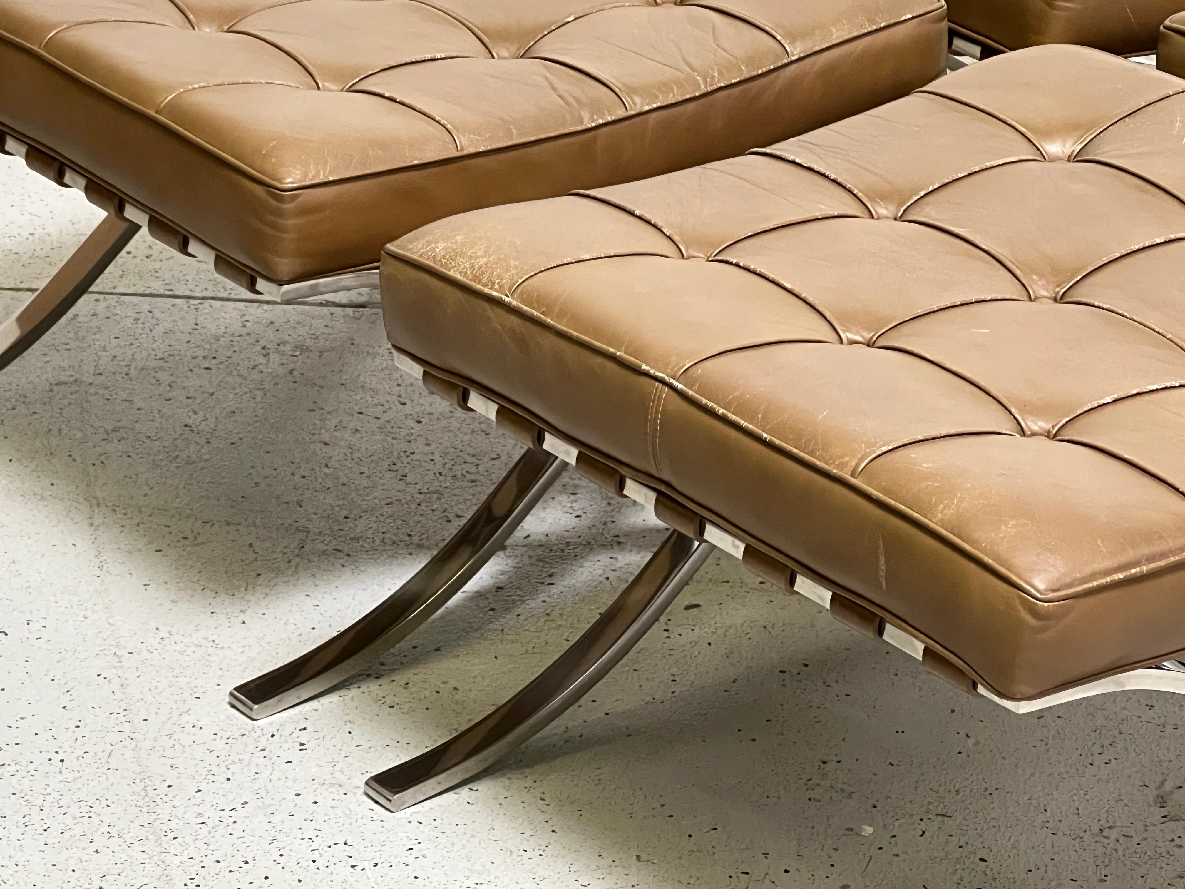 Barcelona stools in polished stainless steel and patinated brown leather. Designed by Mies van der Rohe for Knoll. Priced and sold individually.