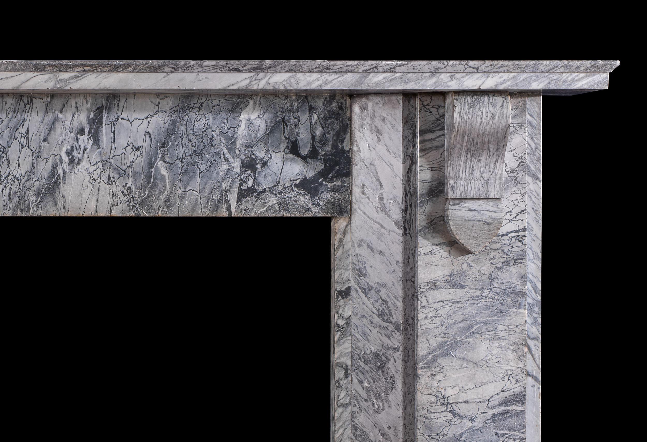 A large Victorian chimneypiece in a striking, dramatically veined bardiglio fiorito marble. The large shelf rests on simply carved corbels, which flank a wide and plain frieze, over wide plain jambs with angled returns. This fireplace would be well