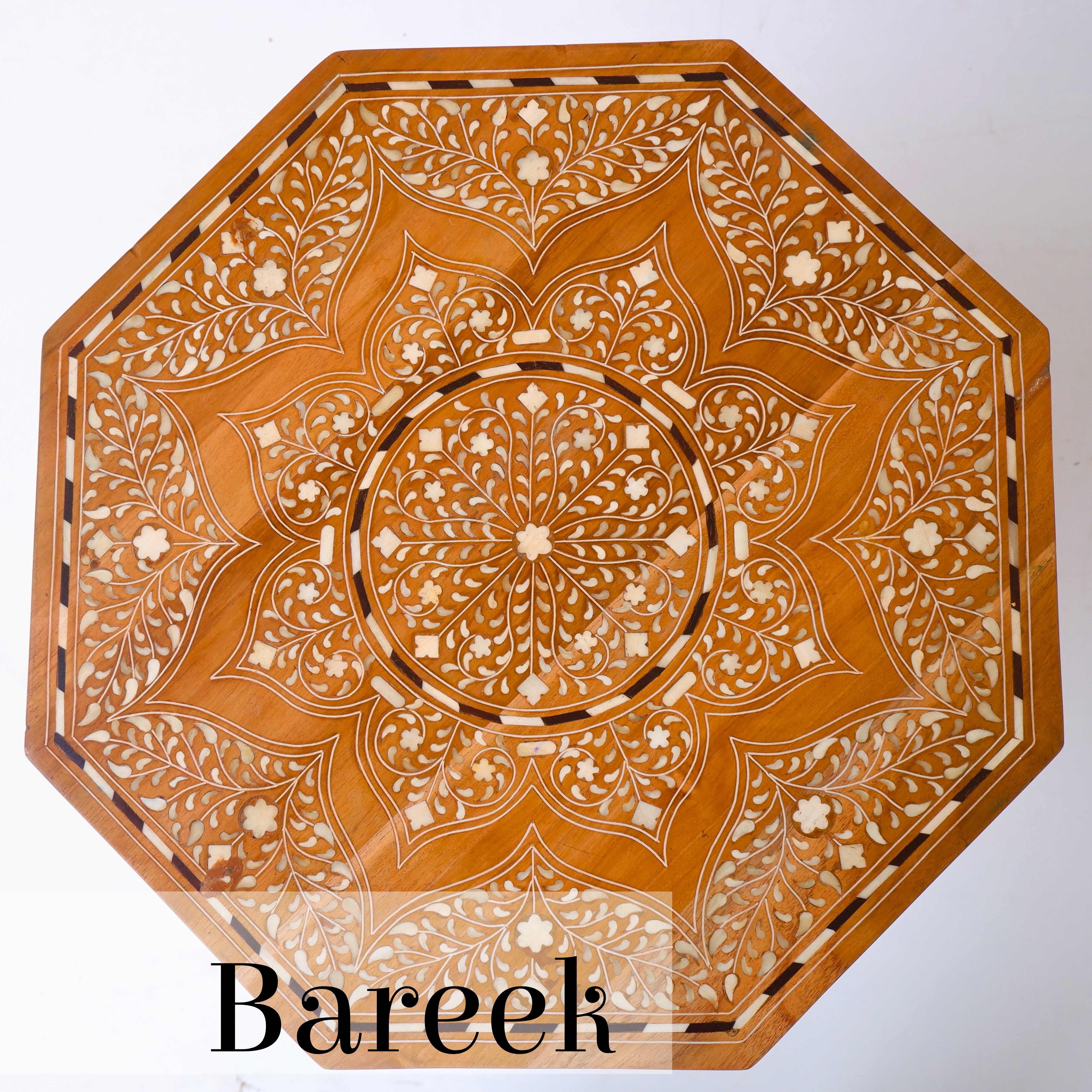 The incorporation of Bareek work( fine detailing), of bone on solid wood takes this end table to another level of artistry and craftsmanship. The combination of intricate bone inlay patterns with the solidity of the wood creates a sense of depth and