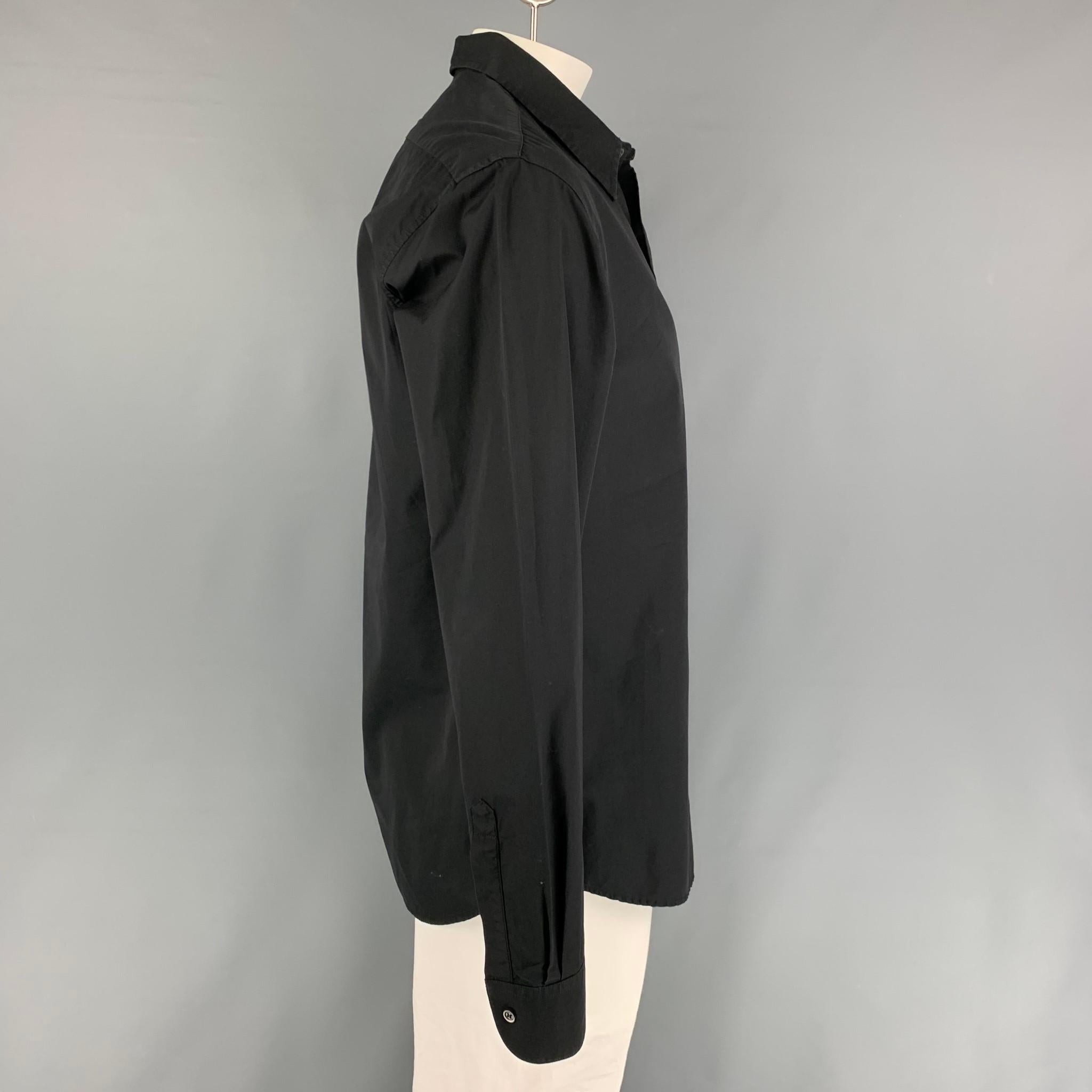 BARENA long sleeve shirt comes in a black cotton featuring a spread collar and a hidden placket closure. Made in Italy.

Very Good Pre-Owned Condition.
Marked: 54

Measurements:

Shoulder: 19 in.
Chest: 44 in.
Sleeve: 27.5 in.
Length: 32 in. 