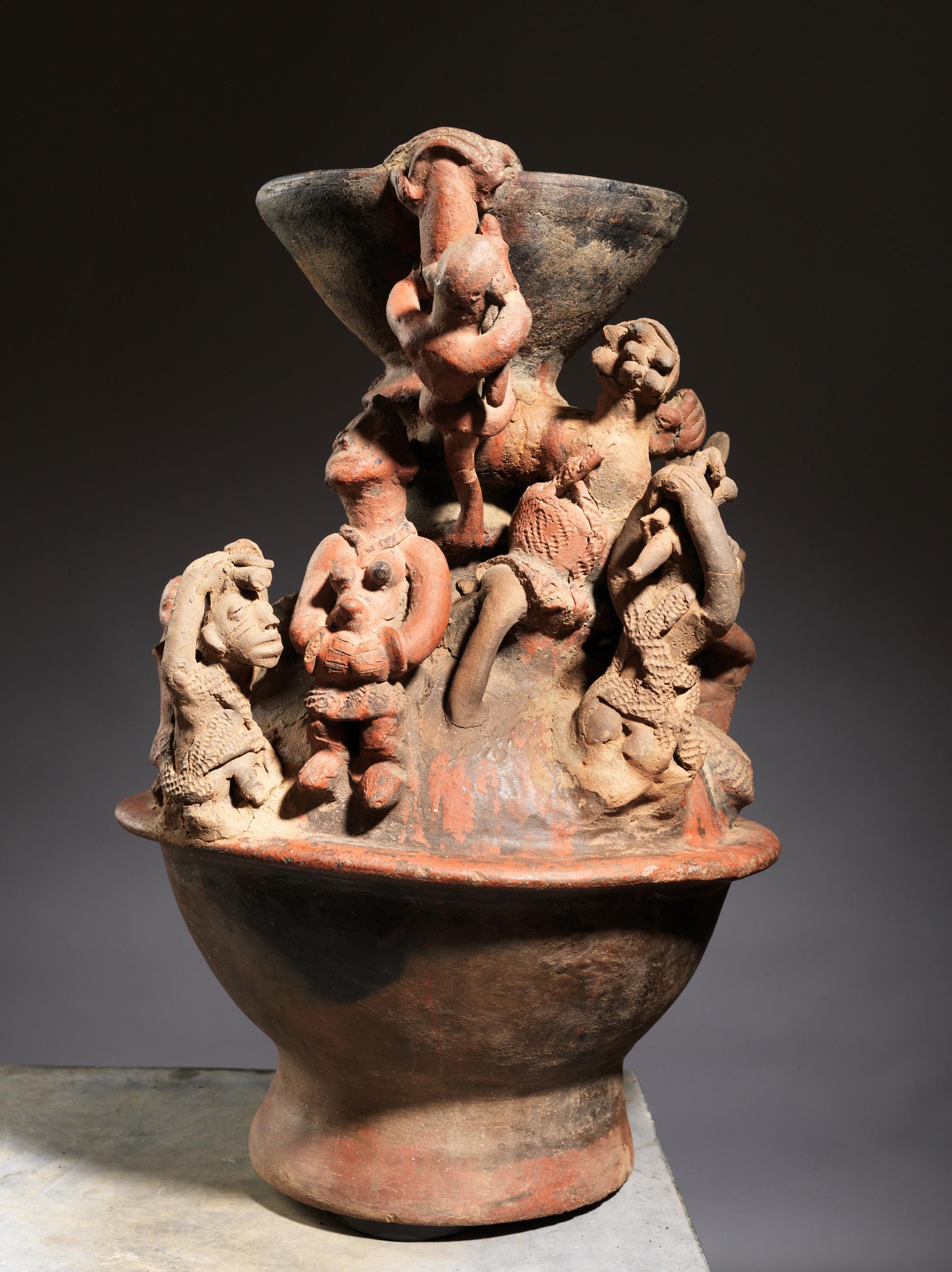This piece of a pottery vessel, embellished with high relief figures, was made by women of the ethnic group of the Bariba (or Baatonu) in the northern provinces of Benin. The Bariba potters passed their trade from mother to daughter. They didn’t