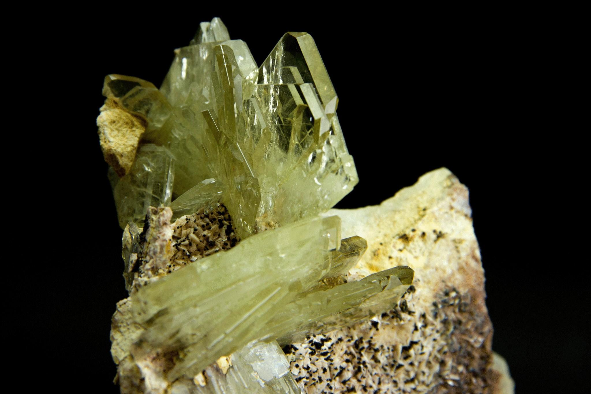 From Cerro Warihuyn, Huanuco, Peru

Lustrous cluster of smoky transparent flattened barite crystals in parallel growth on brown matrix. The barite crystals are tabular rectangular blades with sharp edge faces all throughout the crystal with a smoky