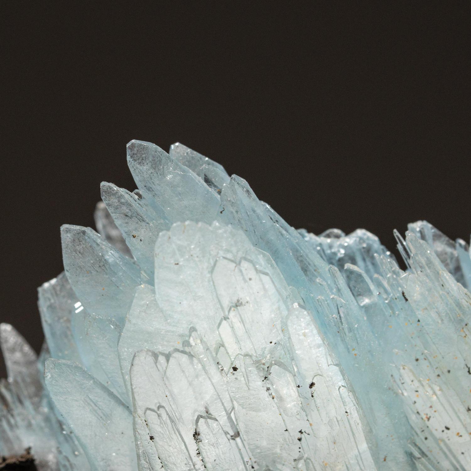 From Jebel Ouichane, Beni Bou Ifrour, Nador, Nador Province, Oriental Region, Morocco

Lustrous transparent blue-gray bladed barite crystals in intersecting aggregates of subparallel crystals on geothite. The small transparent colorless barite