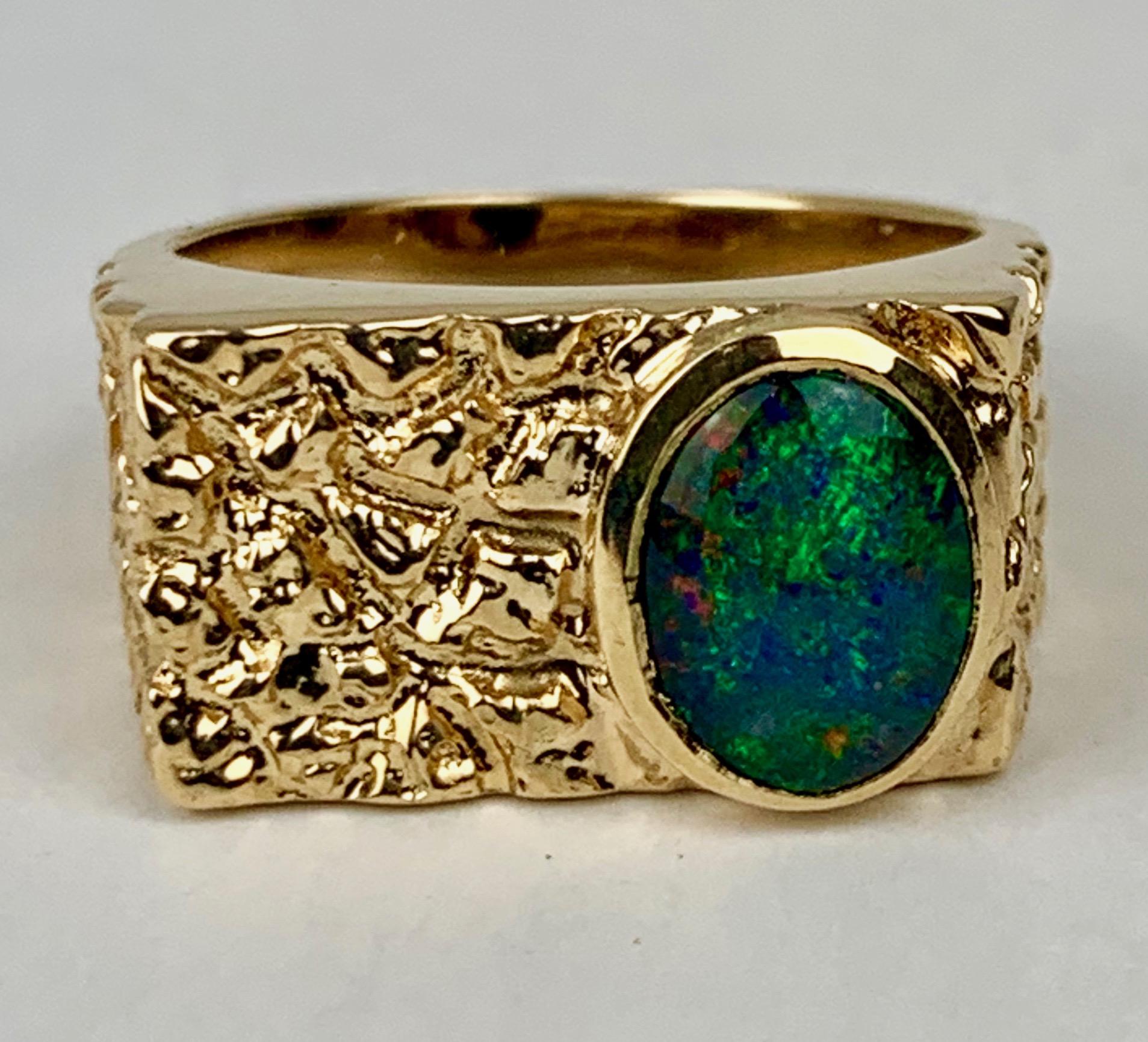 1970's bark textured flat top 14k gold ring with an oval doublet opal.  The ring is in beautiful original condition. Marked 14k on the inner band.
Size 5.25 (can be sized)

Professionally cleaned and polished.
8 grams