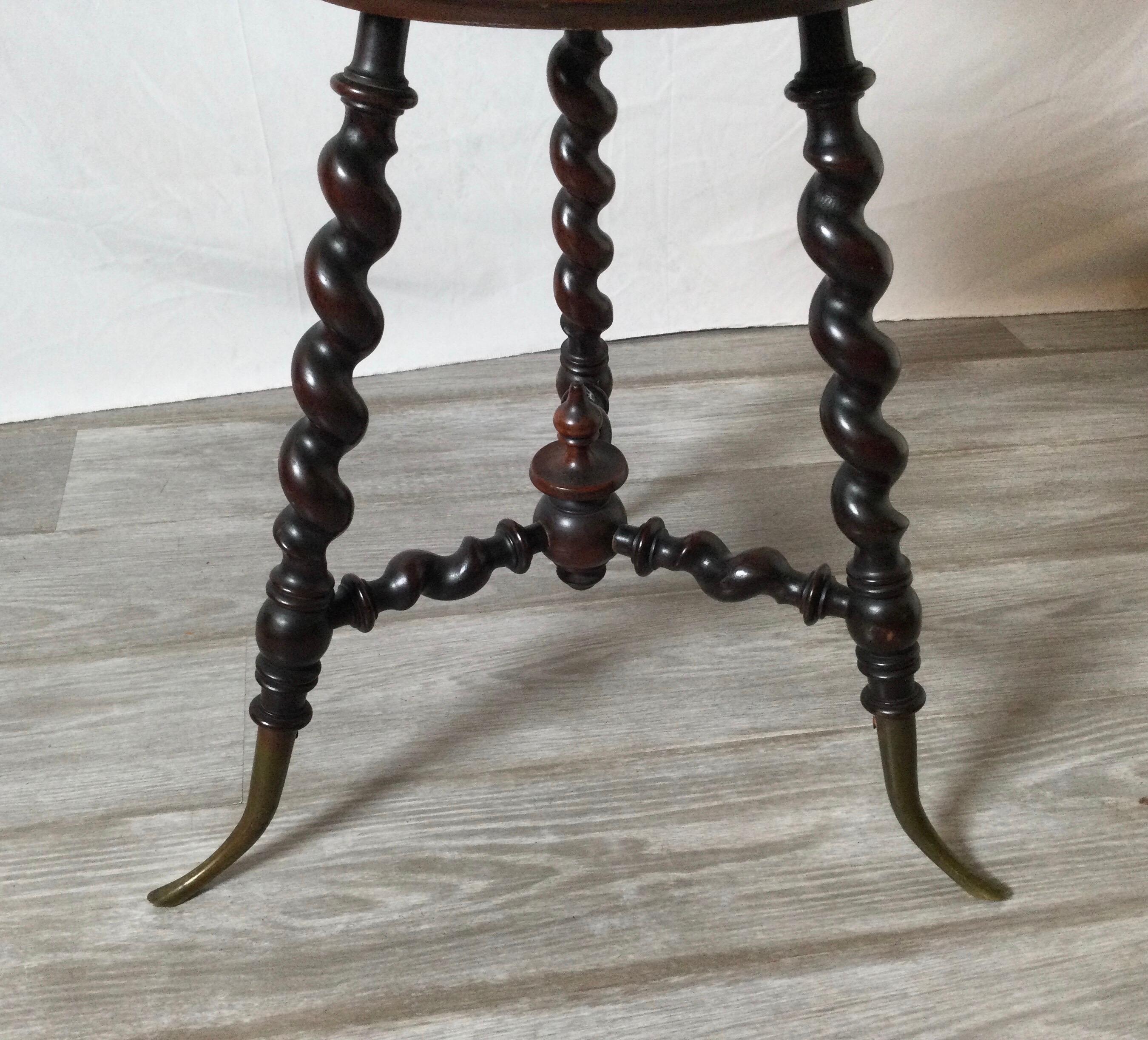 Barley twist Aesthetic Movement plant stand table attributed to George Hunzinger. Measures: 30” tall by 17” in diameter. Brass feet. Good age appropriate condition. One drop has a chip and on the rip is a ruff spot.