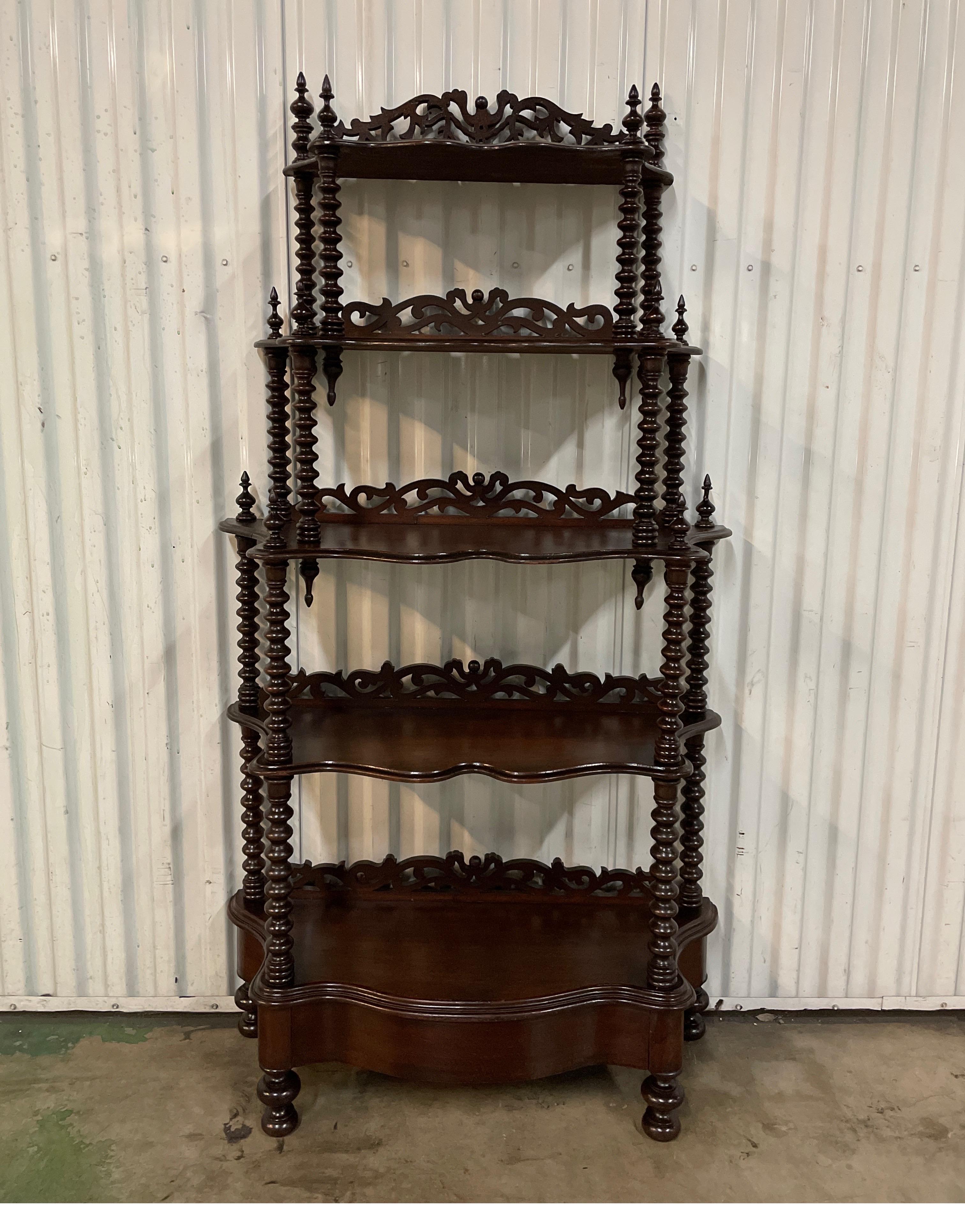 19th century five tier graduated etagere / shelf with barley twist legs topped with hand carved finials. Each shelf is backed with carved stop.