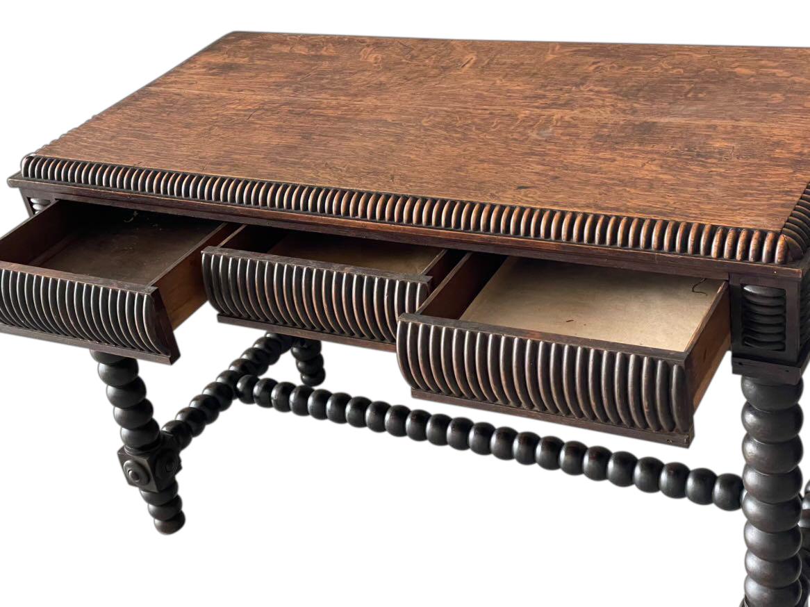 19th century English barley twist leg three drawer side table.
Drawers are disguised in decorative vertical rib design along the apron.
Can also function as a desk.
Oak wood.
Arriving august.