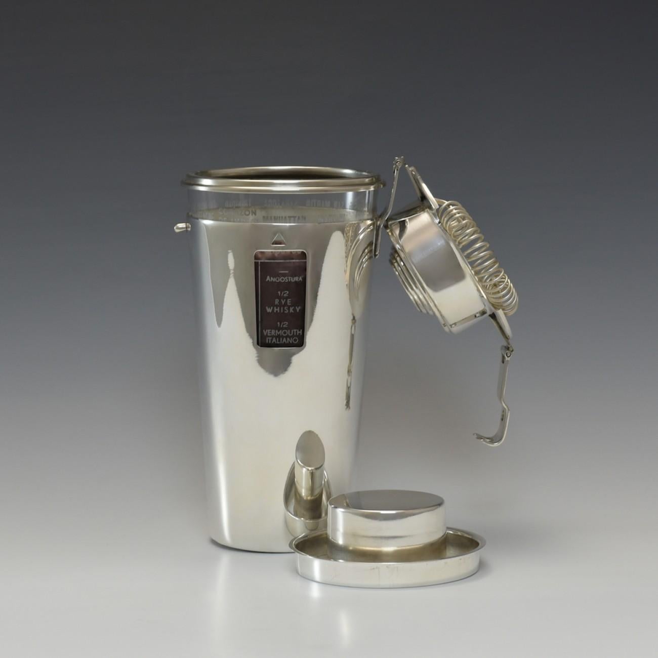 Silver plate and glass recipe cocktail shaker from the 1930s named 