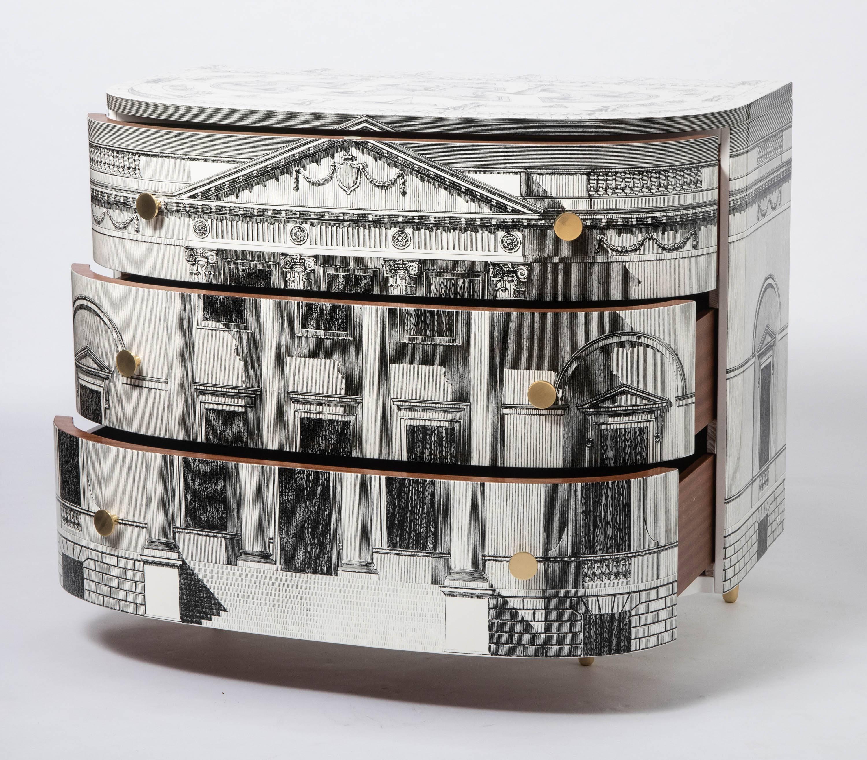 A curved “Palladiana” Commode by Atelier Fornasetti
White and black.
Lacquered and lithographically printed.
Mahogany lined drawers.
Plaque to drawer.
Italy,
circa 2017
Measures: 100 cm wide x 55.5 cm deep x 82.5 cm high.
 