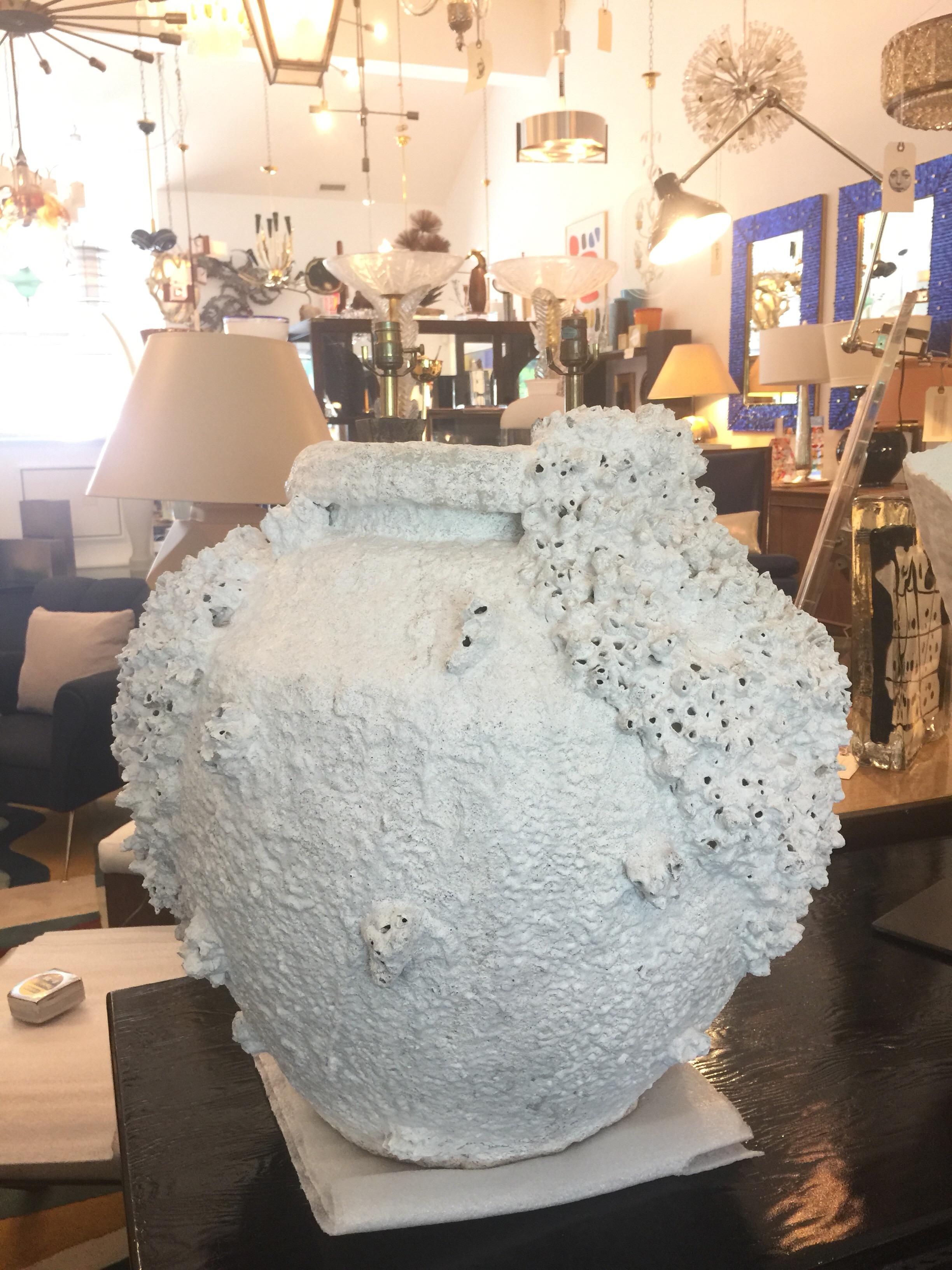 This very large and all natural vessel has encrusted clusters of sea sponge and barnacles - it is an off-white tone. Very heavy and amazing! Rich in texture and sculptural.