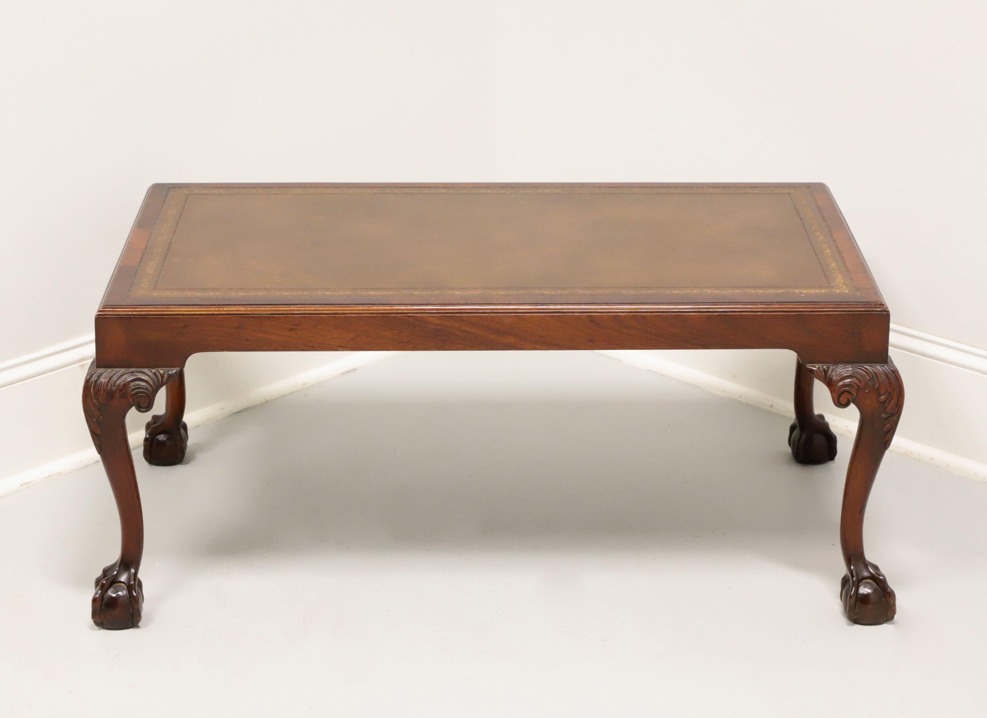 A rectangular shaped coffee table in the Chippendale style by Barnard & Simonds. Mahogany with embossed leather ogee edge top, smooth apron, acanthus leaf carved to knees, cabriole legs, and ball in claw feet. Made in Grand Rapids, Michigan, USA, in