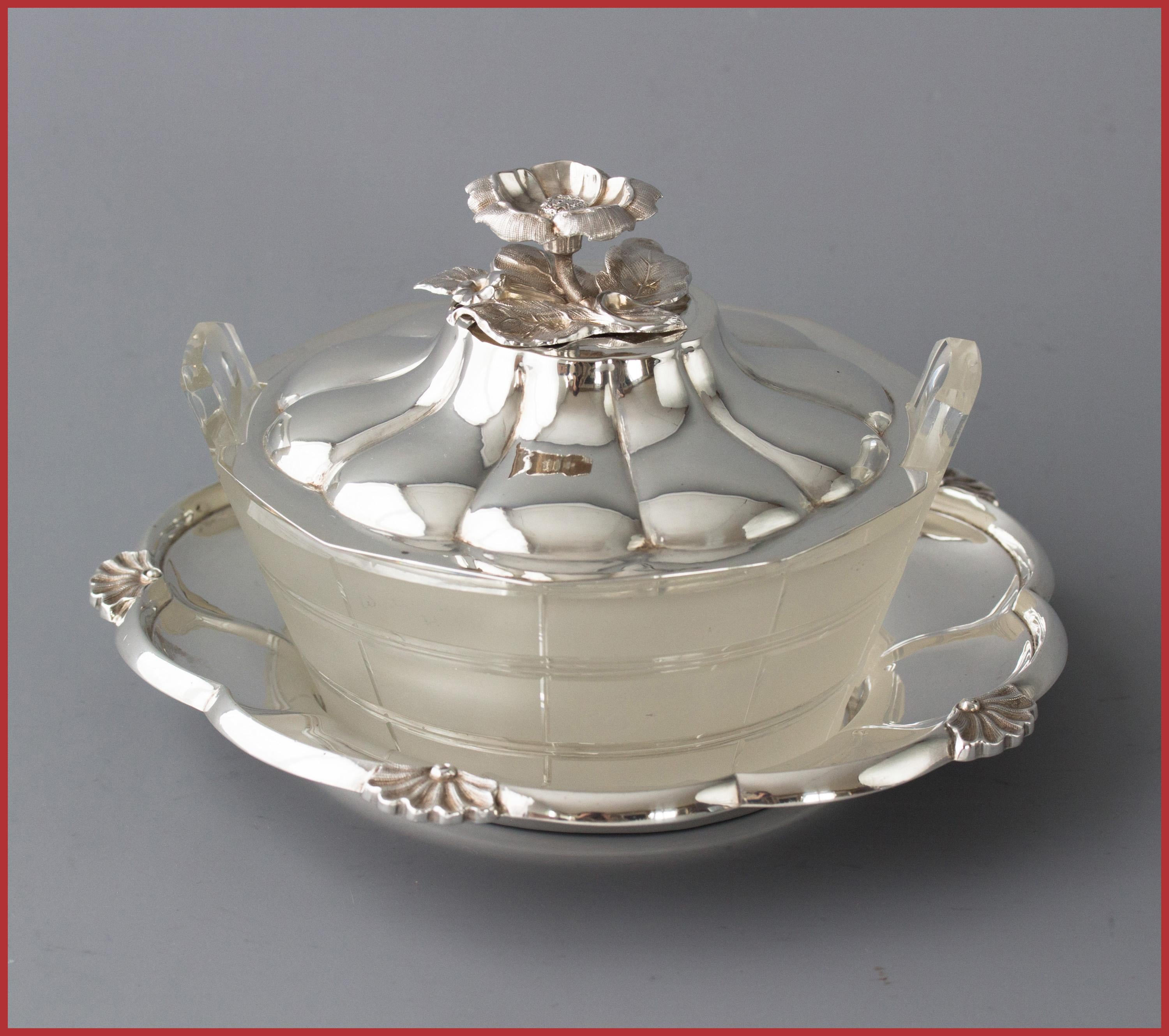 A very good quality circular silver butter dish with a cut glass receptacle in the shape of a churn. The base of the dish of petal form with shells to five of the lobes. The domed, fluted lid with a buttercup finial. 

All the parts are marked for