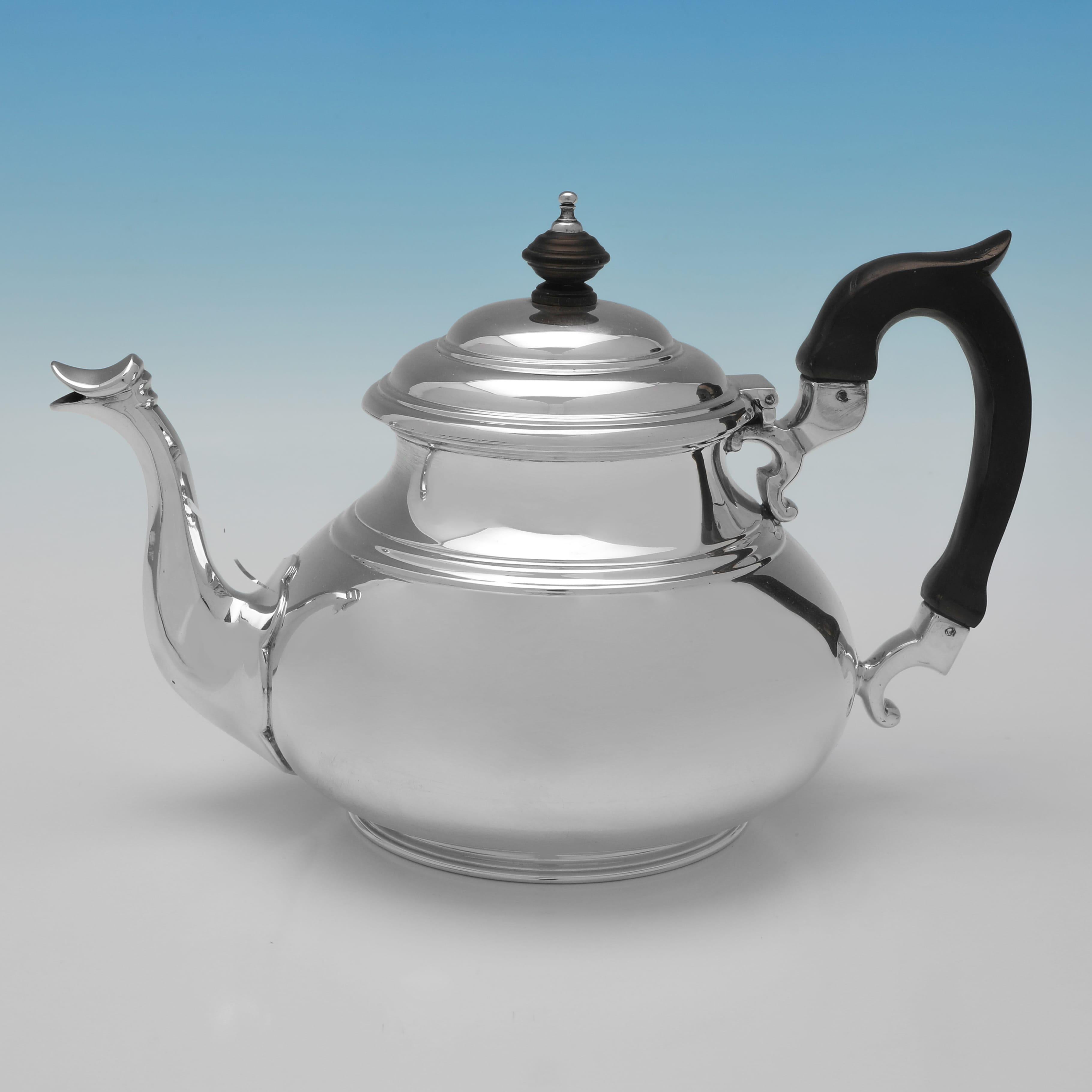 Hallmarked in London in 1960 by Edward Barnard & Sons, this Elizabeth II period, Sterling Silver 4 Piece Tea Set, comprises a coffee pot, a teapot, a sugar bowl and a cream jug, all of which are plain in design with reed detailing throughout. The