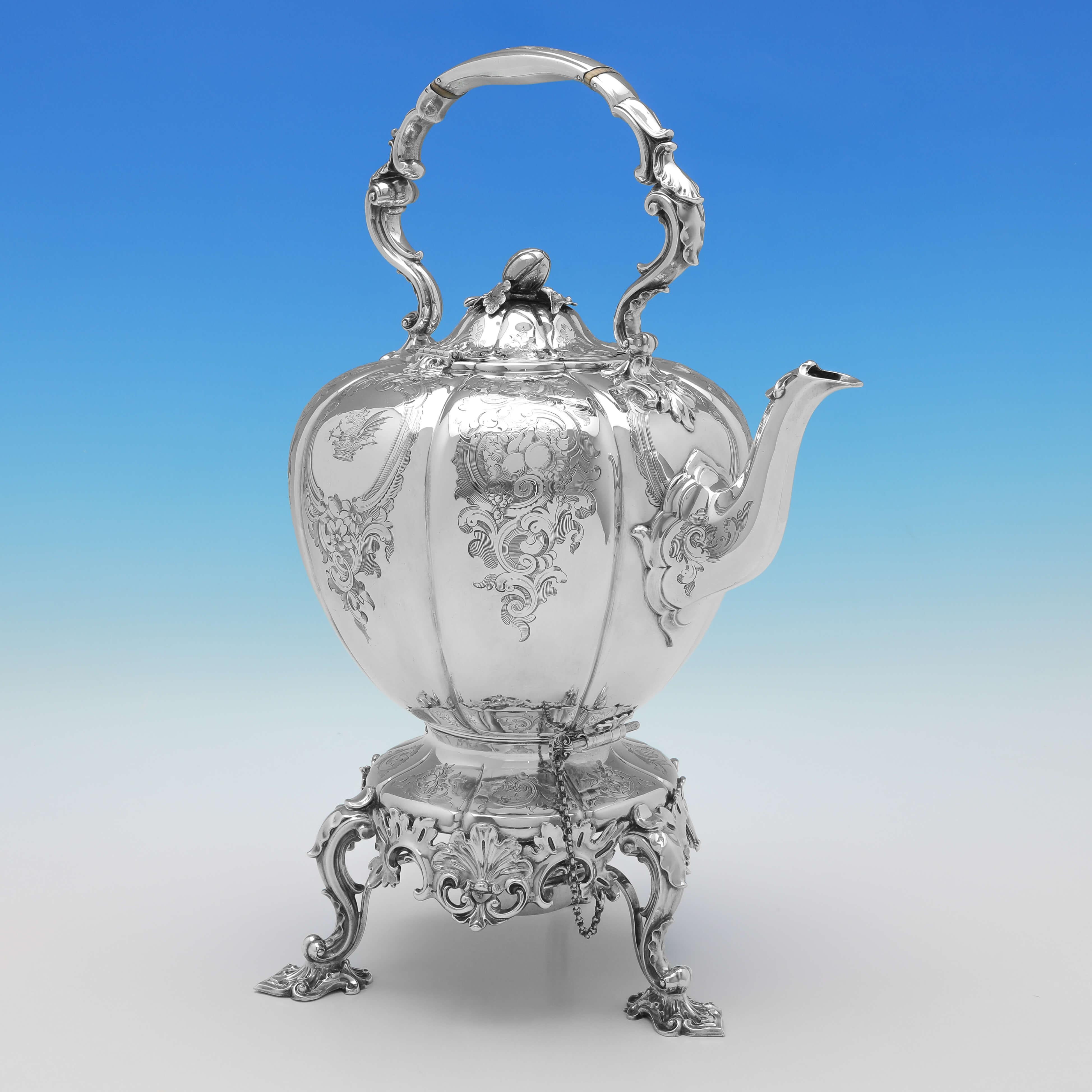 Hallmarked in London in 1855 by Barnards, this attractive and wonderfully engraved, Victorian Antique Sterling Silver Kettle, stands on a hinged stand with a fitted burner underneath. 

The kettle on stand measures 17