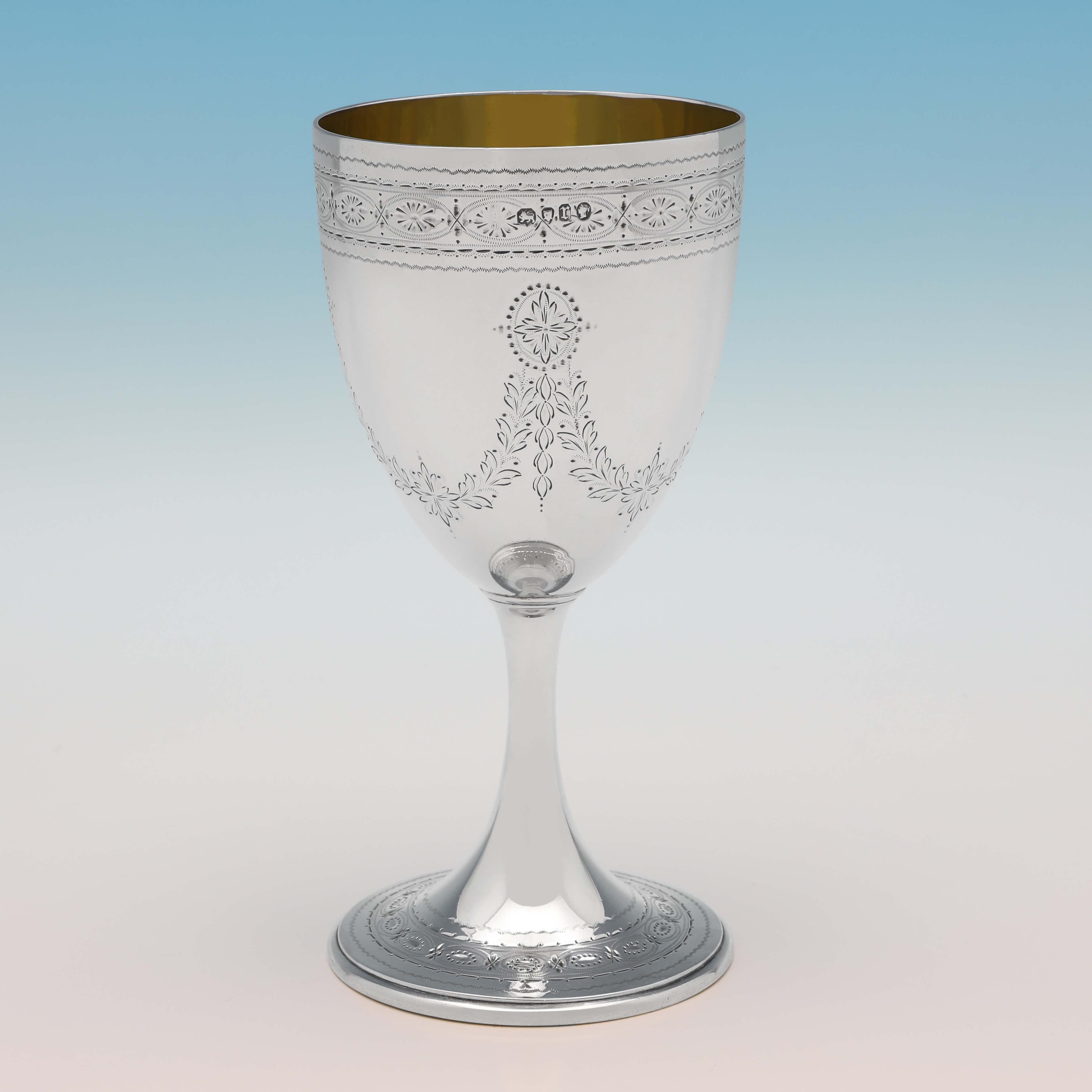 Hallmarked in London in 1872 by Barnards, this attractive, Victorian, antique sterling silver goblet, features bright cut engraved decoration throughout, and a gilt interior. The goblet measures 6.5