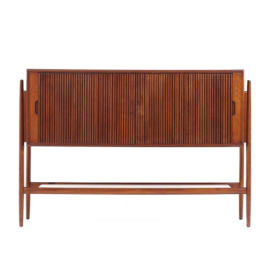Barney Flagg for Drexel Mid Century Walnut Tambour Door Credenza

This credenza measures: 53.75 wide x 17 deep x 36.5 inches high

All pieces of furniture can be had in what we call restored vintage condition. That means the piece is restored upon
