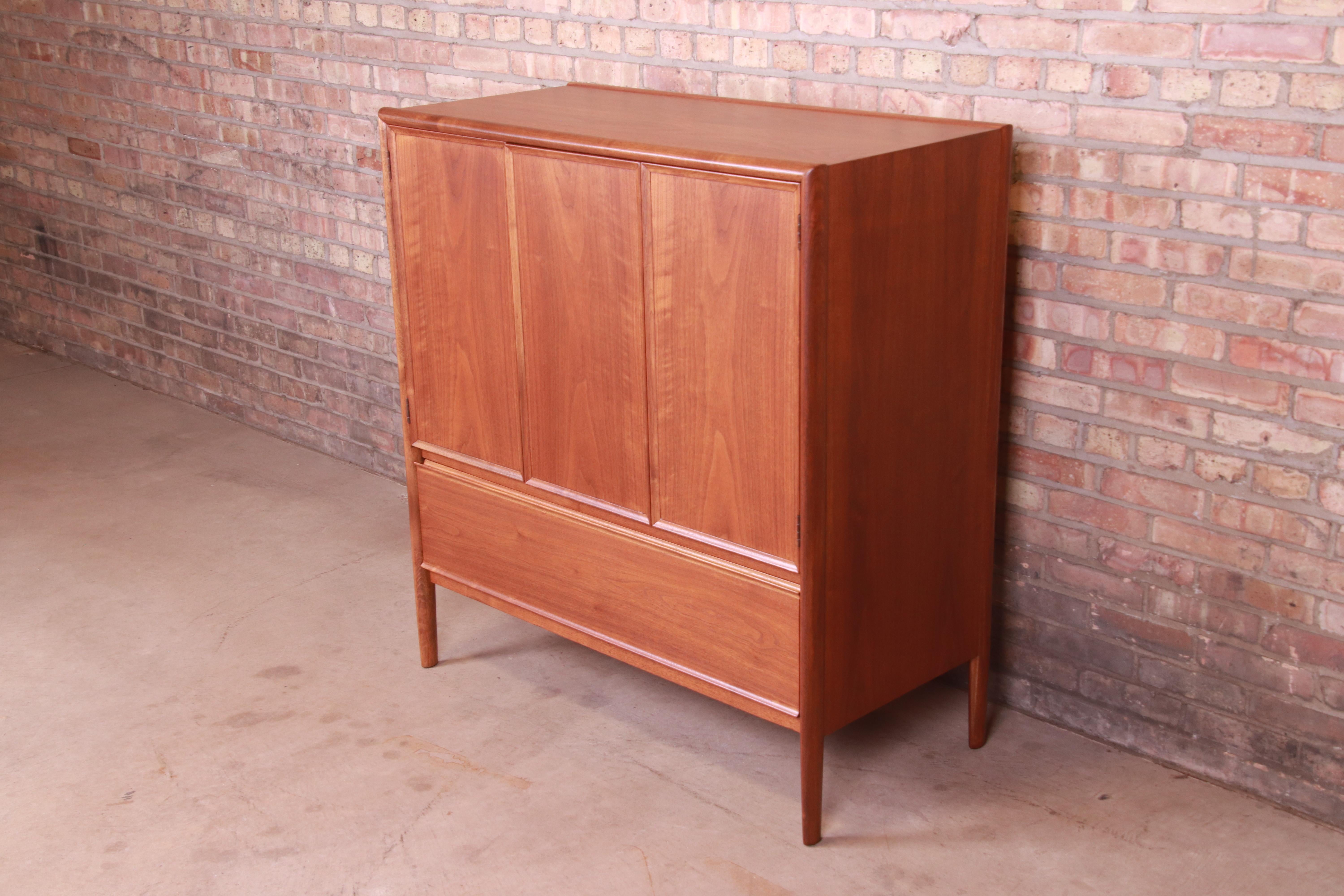 An exceptional Mid-Century Modern walnut highboy dresser or gentleman's chest with unique flip-up vanity mirror

By Barney Flagg for Drexel Furniture 