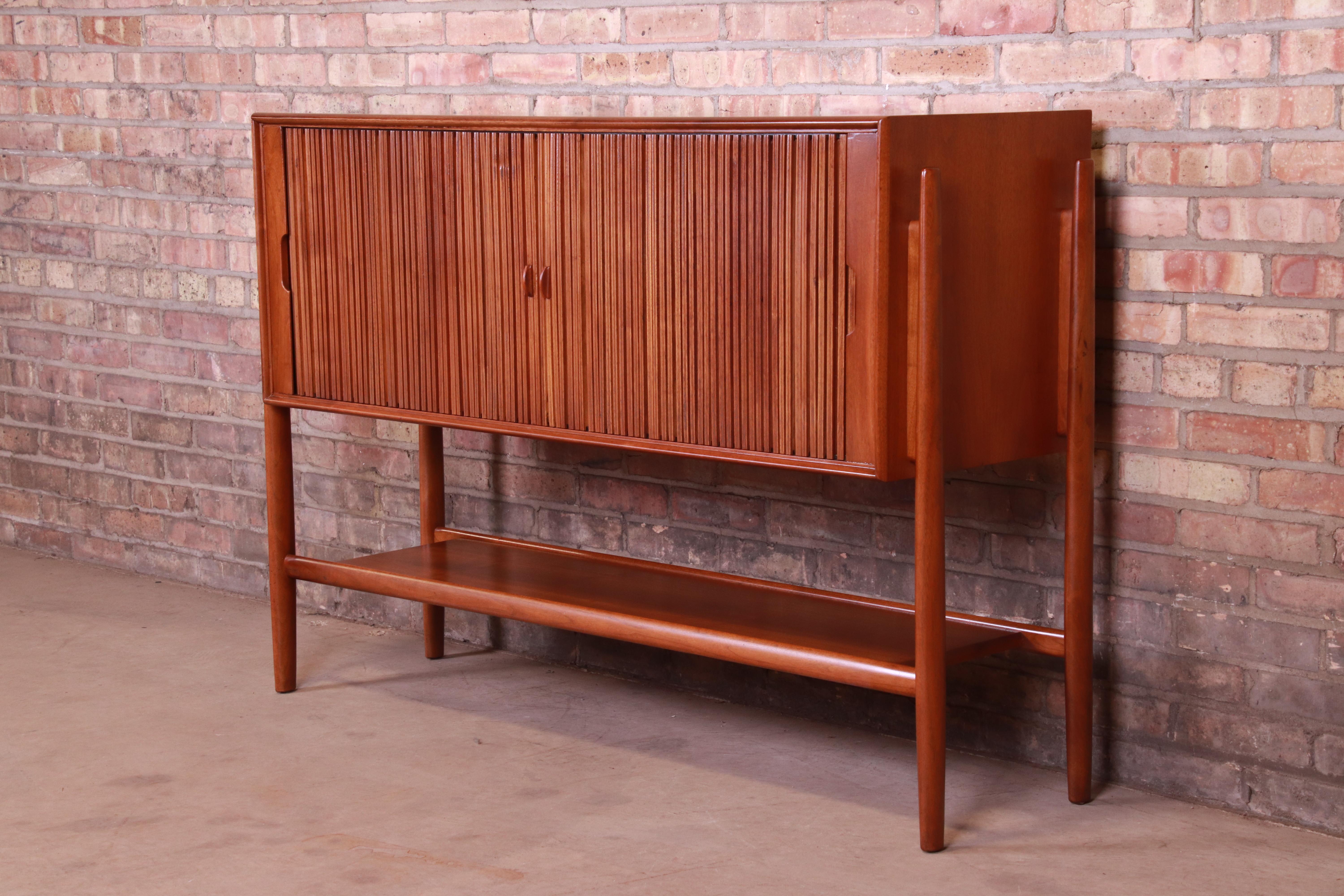 An exceptional Mid-Century Modern walnut tambour door sideboard credenza or bar cabinet

Featuring sleek Danish-inspired design similar to pieces by Arne Vodder and Finn Juhl

By Barney Flagg for Drexel 
