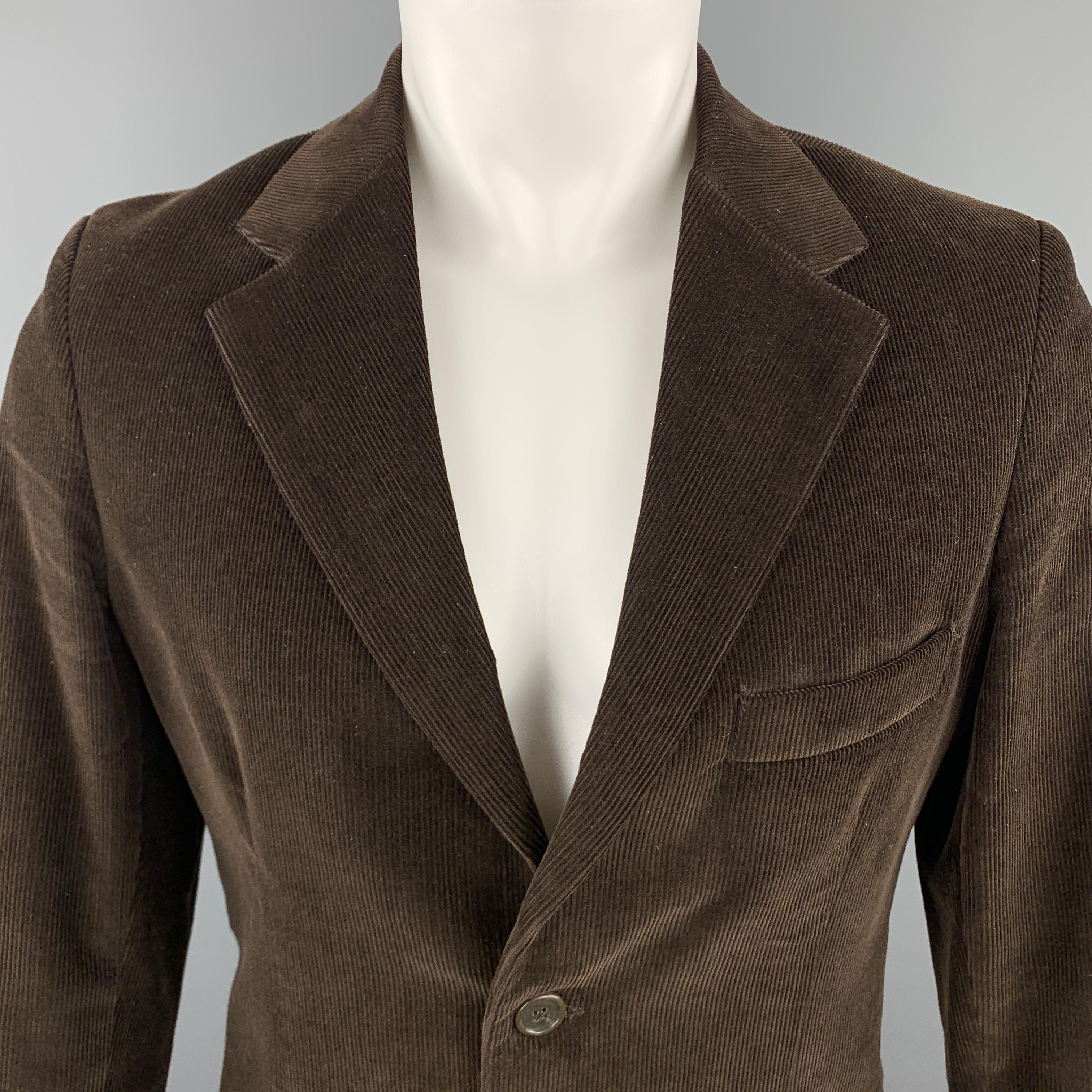BARNEY'S CO-OP sport coat comes in a solid brown corduroy cotton material, with a notch lapel, slit and flap pockets, two buttons at closure, single breasted, buttoned cuffs, and a single vent at back. Made in Italy.

Excellent Pre-Owned