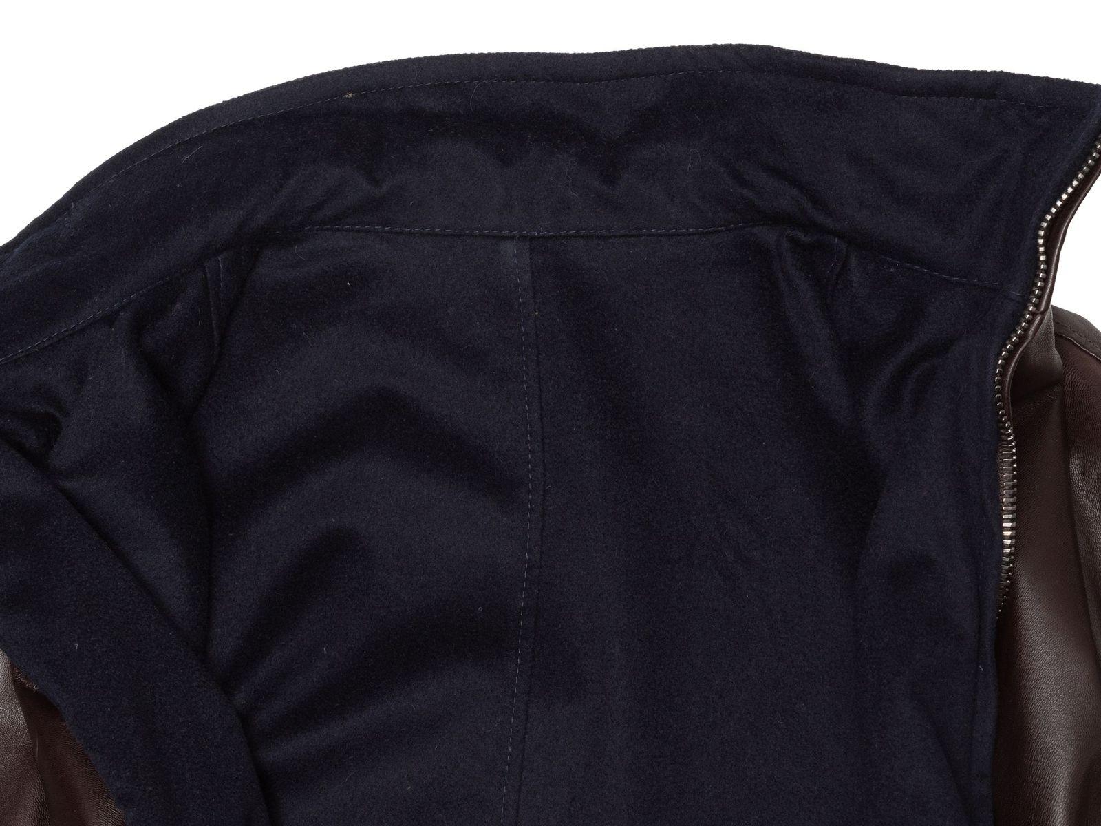 Product Details: Brown leather and navy wool reversible jacket by Barney's New York. Stand collar. Dual hip pockets. Zip closure at center front. 40