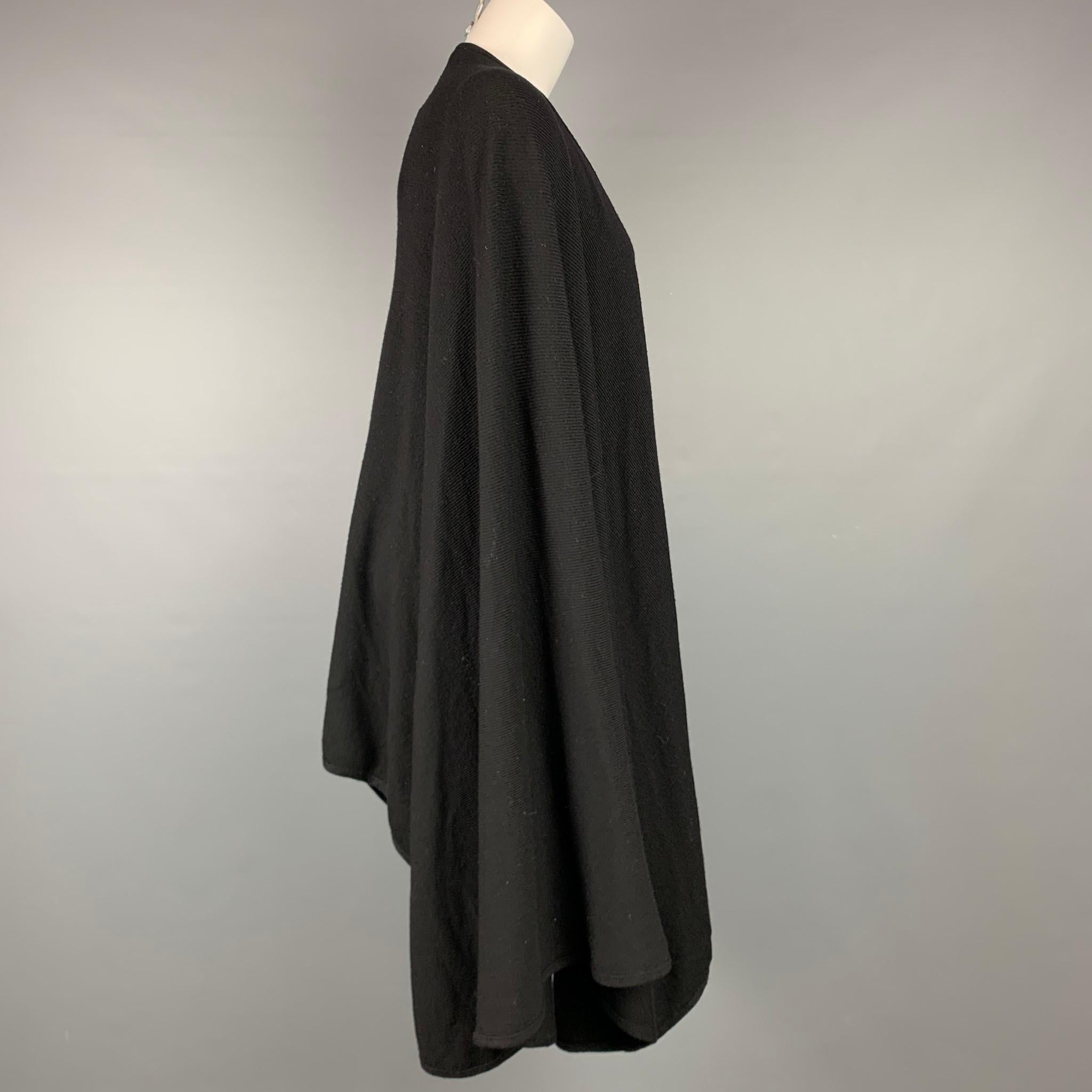 BARNEY'S NEW YORK poncho comes in a black knitted merino wool featuring a open front. Made in Italy.

Very Good Pre-Owned Condition.
Marked: One size

Measurements:

Shoulder: 17.5 in.
Sleeve: 37 in.
Length: 31 in. 