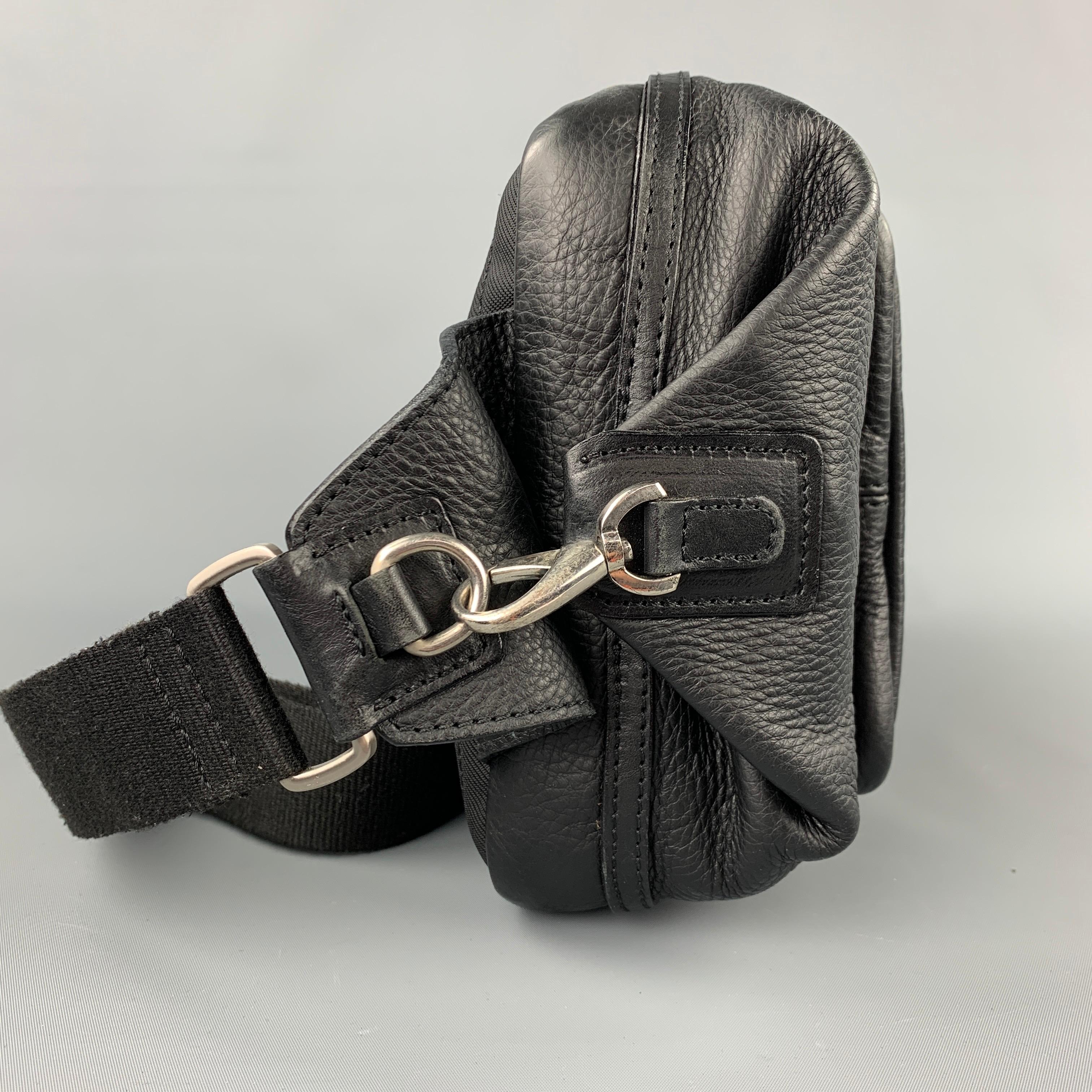 BARNEY'S NEW YORK bag comes in a black pebble grain leather featuring a crossbody strap, front pockets, inner slots, and a zipper closure. Made in Italy.

Very Good Pre-Owned Condition.

Measurements:

Length: 12 in.
Width: 2 in.
Height: 8 in.
 