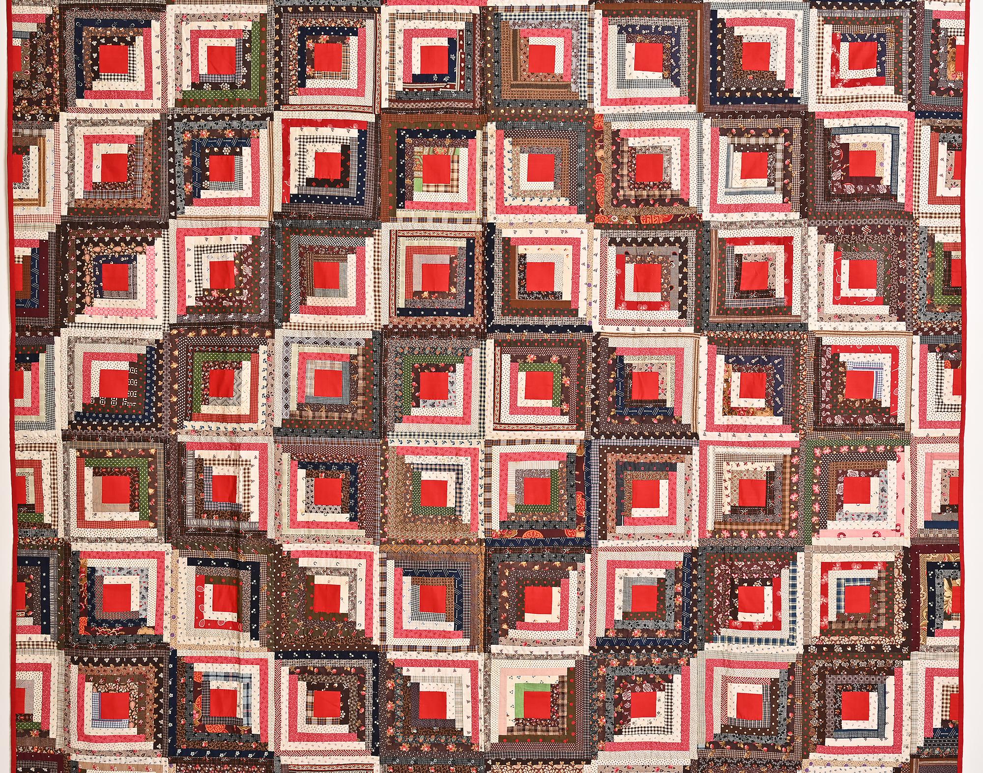 This is a wonderful example of a classic Barnraising Log Cabin quilt. It is especially crisp and bold. It is in unwashed, unused condition. The solid red centers really stand out next to the printed multicolor fabrics. 
