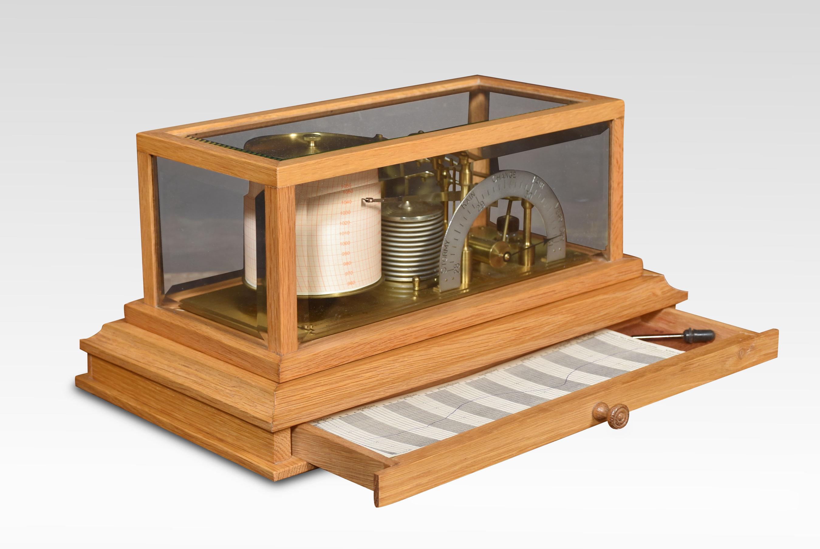 Unusual oak-cased barograph and barometer by Negretti & Zambra, having five glazed removable lid. The mechanical eight-day movement is housed in the drum, fitted with a seven-day chart that covers one full rotation of the drum. The ink trace, or