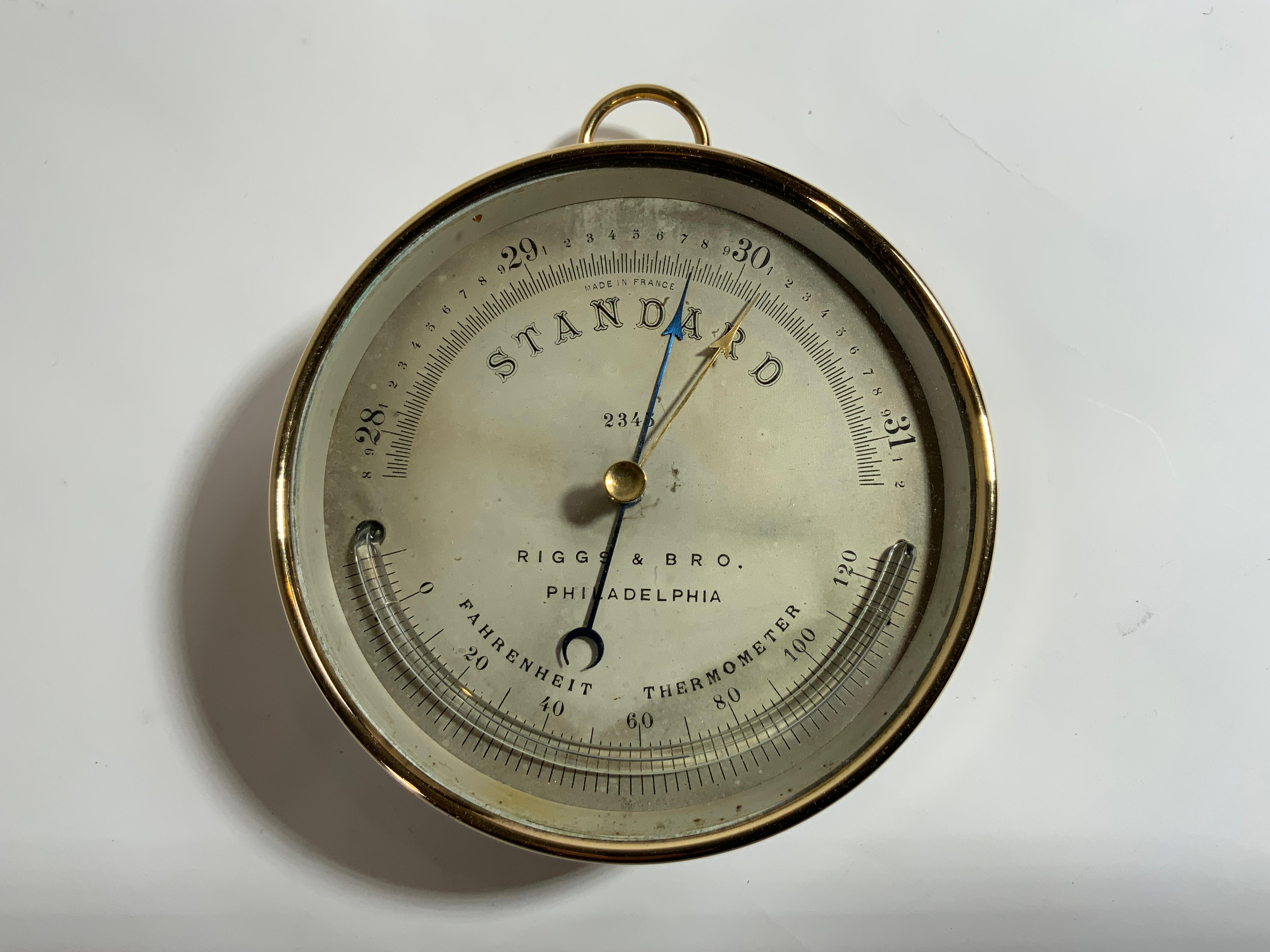 Solid brass French made barometer by Riggs and Brother of Philadelphia. With Fahrenheit thermometer. With hanging ring and screw flange. Adjustment hole on rear. Circa 1900.

Overall Dimensions: 2