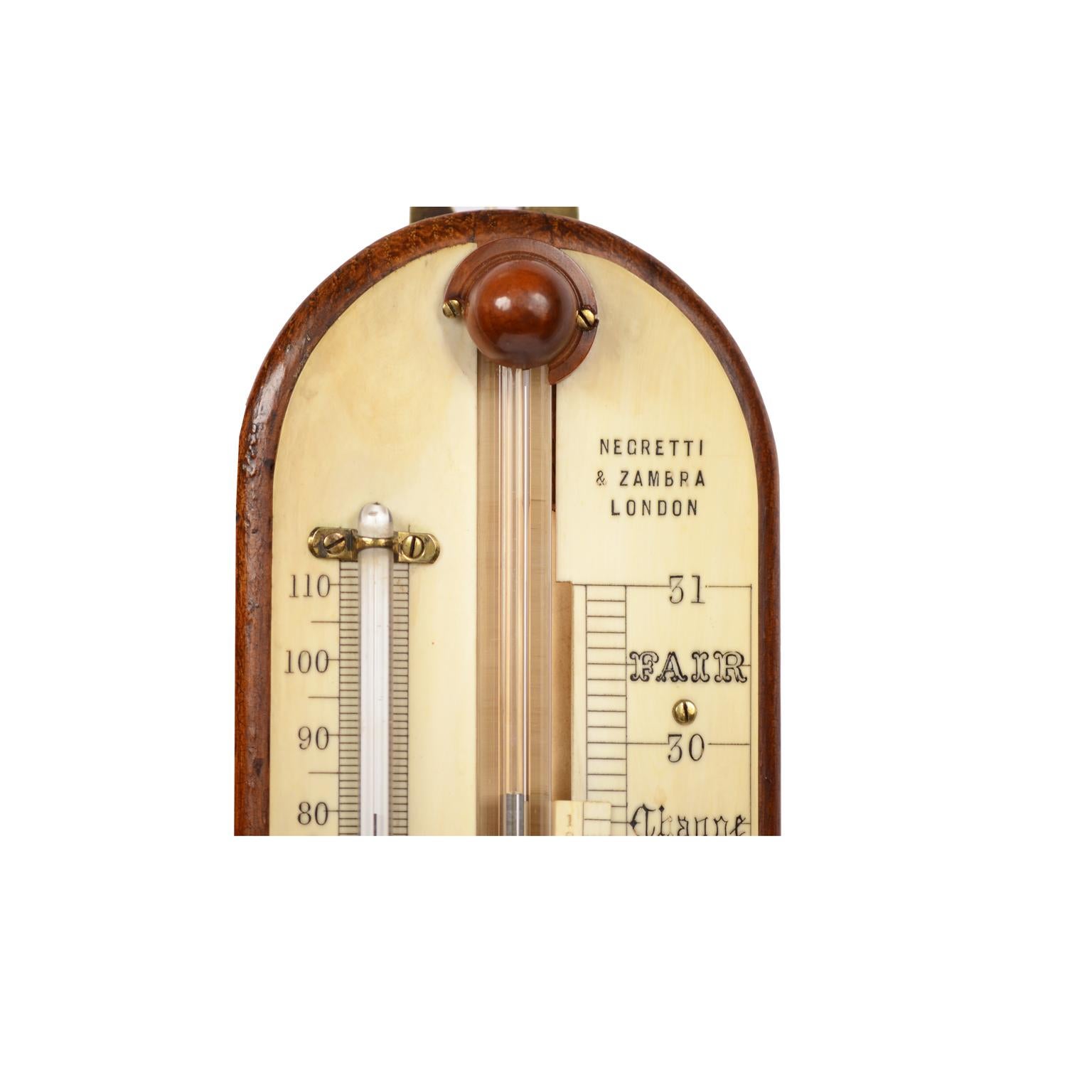 English stick oak barometer signed Negretti & Zambra, mid-19th century, complete with thermometer, Vernier reading the variation of atmospheric pressure and adjusting screw for setting the level of mercury. Very good condition and in order.