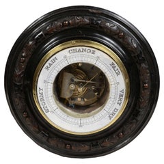 Antique Aneroid wall barometer in carved wood brass and glass late 19th century.