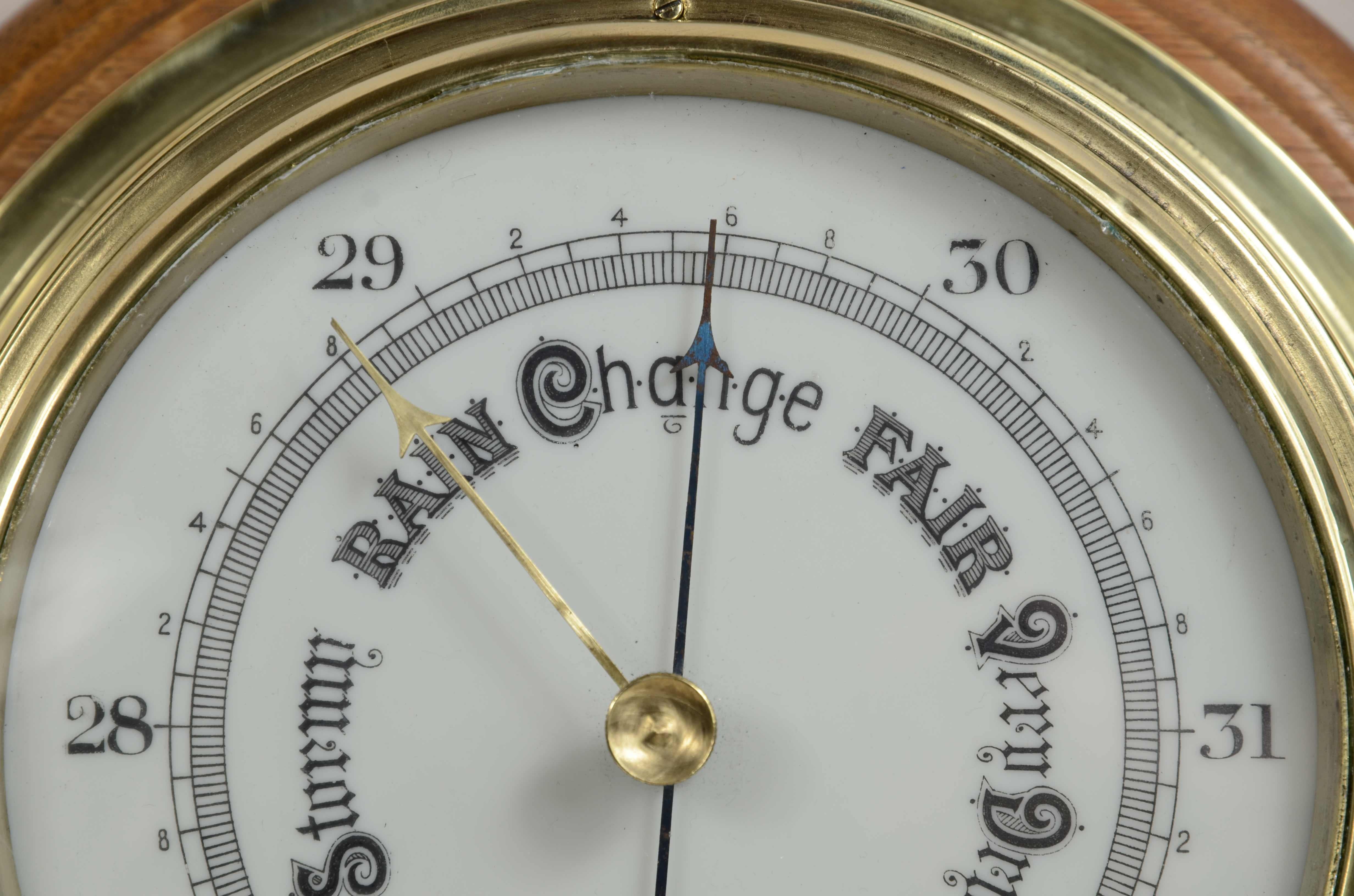 Early 20th Century Brass wall-mounted aneroid barometer  signed John Barker & Son, early 1900s.