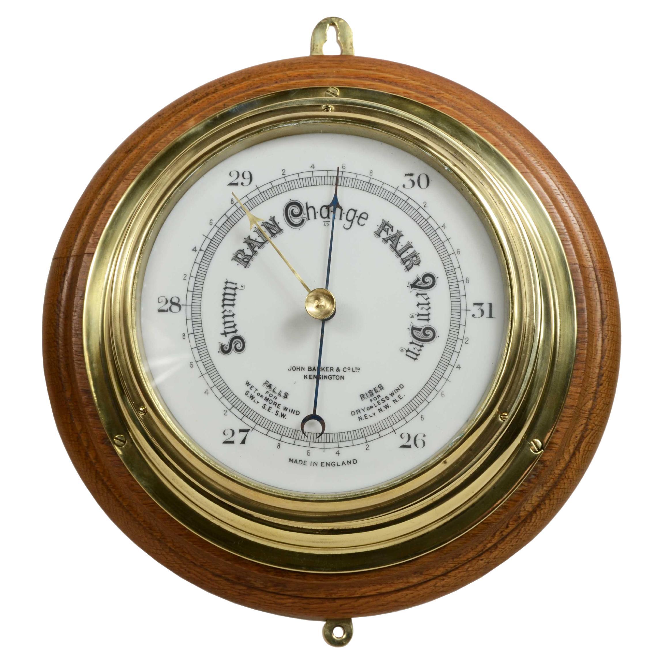 Brass wall-mounted aneroid barometer  signed John Barker & Son, early 1900s.