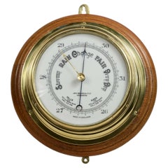 Brass wall-mounted aneroid barometer  signed John Barker & Son, early 1900s.